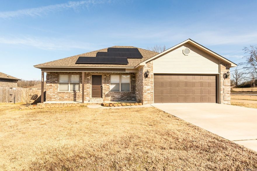 Open-concept floor plan with vaulted ceilings, walk-in shower, and a spacious laundry room. Situated on a corner lot with a fenced yard and covered back porch. Features an extra parking pad with plug—ideal for a camper or RV—plus solar panels for added efficiency.  No smoking or vaping allowed in the house or garage. No pets. Application, background check, rental verification, and security deposit required.