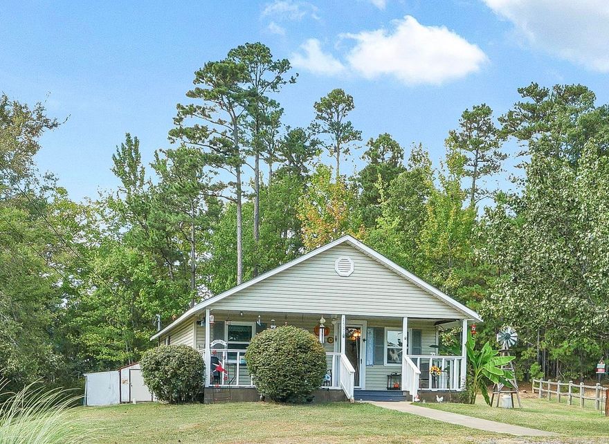 This is an adorable 2 bedroom home on a large .60 acre lot in Mena, Arkansas! Everything is so clean, neat and tidy! It has many updates such as nice low maintenance siding and window. There is a nice large 18x20 metal carport as well as out buildings for storage. The house sits back off Reine street and behind the church so it has privacy. This would make a great move in ready primary home or would be a great long term or short term rental!