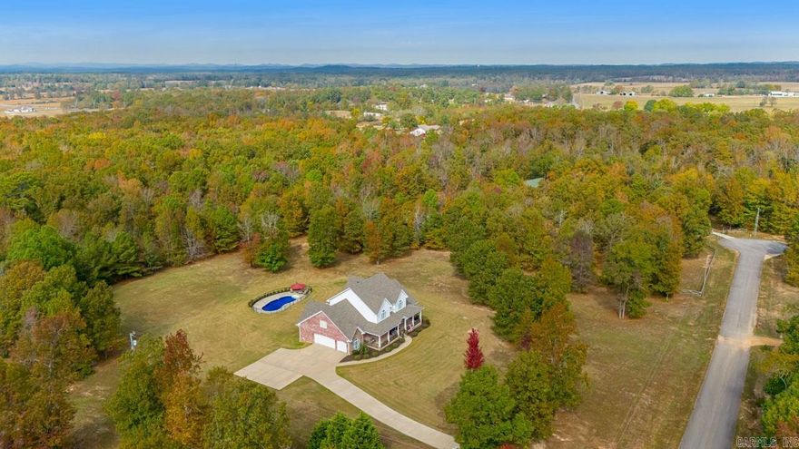 Gorgeous Grand Country Estate! 5 beautiful acres. Inground Pool-new liner 10/23 Pump 21 Primary Suite downstairs & a magnificent 2nd Primary Teenager/adult Suite Upstairs. 2 other bedrooms up as well. 2.5 baths up and 1.5 baths down. Gameroom w/pool table, beautiful wood bar top. Also has beverage cooler & ice maker plus half bath. This home also features Formal Dining and Office w/closet. Rich hardwood flooring thruout. Tile/ wet areas. Spacious gourmet kitchen, granite countertops. Cabinets for everything. Large Walkin pantry. Stained wood coffered ceiling in kitchn & breakfast area. Breakfast area & Living area overlook back porch w/wbfp, Pool and beautiful acreage. Enjoy the wildlife from large porches! Dog wash in laundry room  Front stairway & 2nd stairway to gameroom. Stone Fireplace in Liv area & primary BR FP have vented propane logs. Cook stove top is Propane. Sprinkler in front flower beds only. Safe room in the 3 car garage. New Roof in 2020.  Updated paint colors and elegant Trim work thruout. House is wired for surround sound to speakers inside & out but no system in place. This home is spacious and gorgeous ! See conf remarks