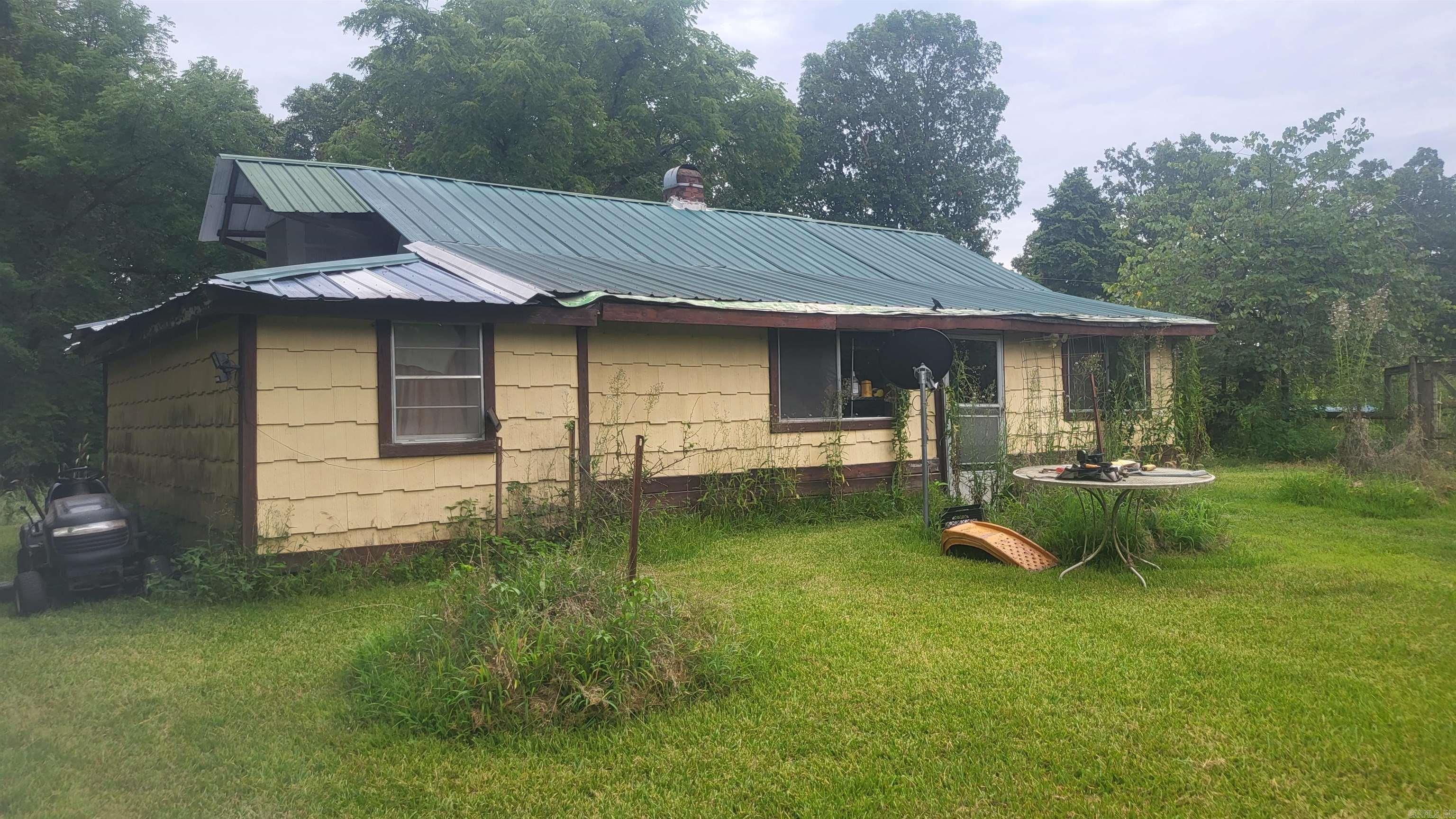 Four parcels of land, total of 6.25 acres! Just off Hwy 71, yet secluded, it feels like you're in the country! Also includes a small house & shed, rock fenced area for garden, large trees, fenced area for livestock, end of road location. Close to amenities