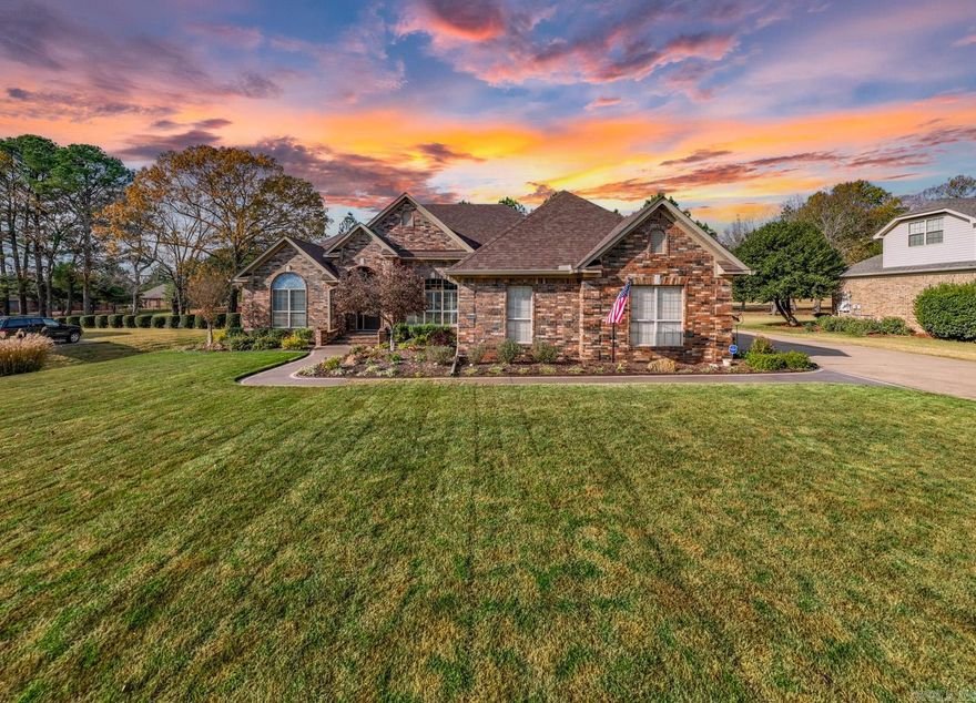 This traditional style home is an all-brick home that sits on a golf course facing lot, with multiple flower beds, and is fully fenced. It has 4 bedrooms and 2.5 baths in a split floor plan design that is open and spacious. Heavy crown molding is evident throughout the home. Both fireplaces have detailed mantels. Recent updates include flooring, painting, new roof (2024) with high efficiency 17 Seer, variable speed HVAC unit installed (2021). There is a 3-car garage with recently updated rails and motors. The 3rd car garage has shelving, built in cabinets & a workbench. Storing items in the attic is a breeze with walk up stairs & a floored attic. Extra insulation was added for an R-44 rating. The outdoor living area is a custom built screened in porch with 600+sq.ft. The open design has a vaulted ceiling lined with custom matched stained white pine, including dimmable recessed lighting & large ceiling fans. Fabulous outdoor kitchen with cabinets made of Spanish oak wood, granite countertops, stainless steel sink, BBQ  microwave, and pull down shades for added privacy. Outdoor TV turns and swivels. Beautiful home that you will want to see centrally located in Conway.