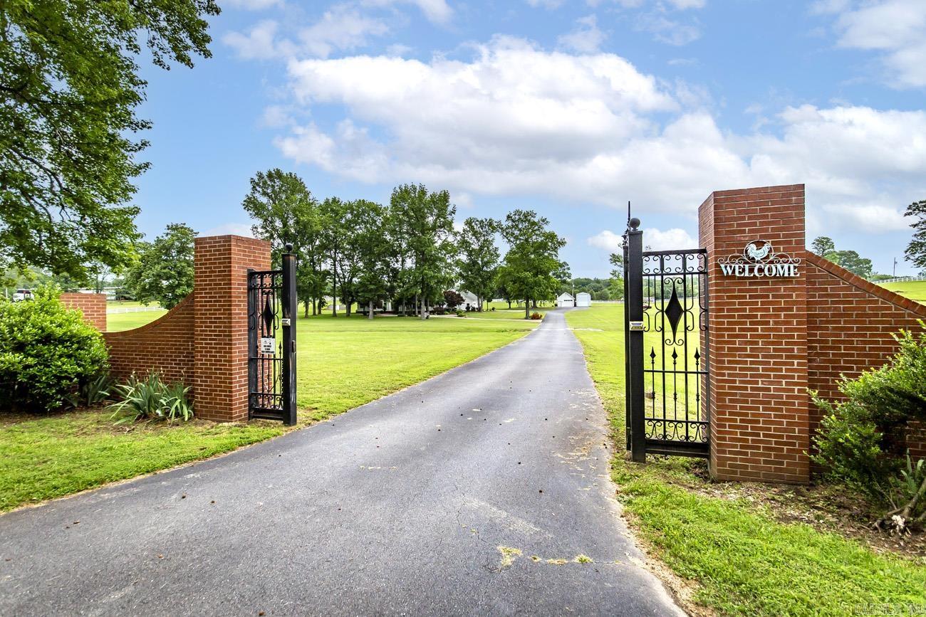 Live in tranquility just minutes from the city! This stunning estate sits on 7.5 +/-acres of landscaped grounds. Custom-crafted molding throughout home. Spacious kitchen with site built cabinets. See through fireplace in family room and kitchen area. Master is separate, has a luxurious master bath. Garage is 1640 sq.ft. heated and cooled, designed to entertain, has kitchen area, 1/2 bath, cedar lined closet. A must to see. Has a 540 sq.ft.est upstairs room with half bath, heated and cooled. Great for parties or living area! Separate work shop, enclosed garage for a 50ft. Motor coach. Barn for 4 horses. You will love the out door breezeway! Don't miss this opportunity, schedule your showing today! We have replated the other 5.2acres, which includes the barn and right side of property. It will not be apart of this parcel. You can see the survey ribbons to show where this property ends, about 18 feet from the driveway.