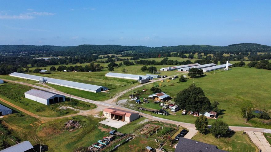 Marion county farm previously ran as a turkey farm could be updated to still run turkeys or chickens. Five barns totaling 120,000 sq ft sitting on 30 pasture acres with a pond all fenced and cross fenced.  There is one 720x50 footing that could have another barn.  Workshop with 3 phase power and bathroom along with 5 - 1000 gallon water tanks. Both city water and a well (40 gpm). Houses are heated with propane. Hook ups for a home or trailer as a residence on site. Separate carport for equipment and a large stacking shed for hay or other storage.