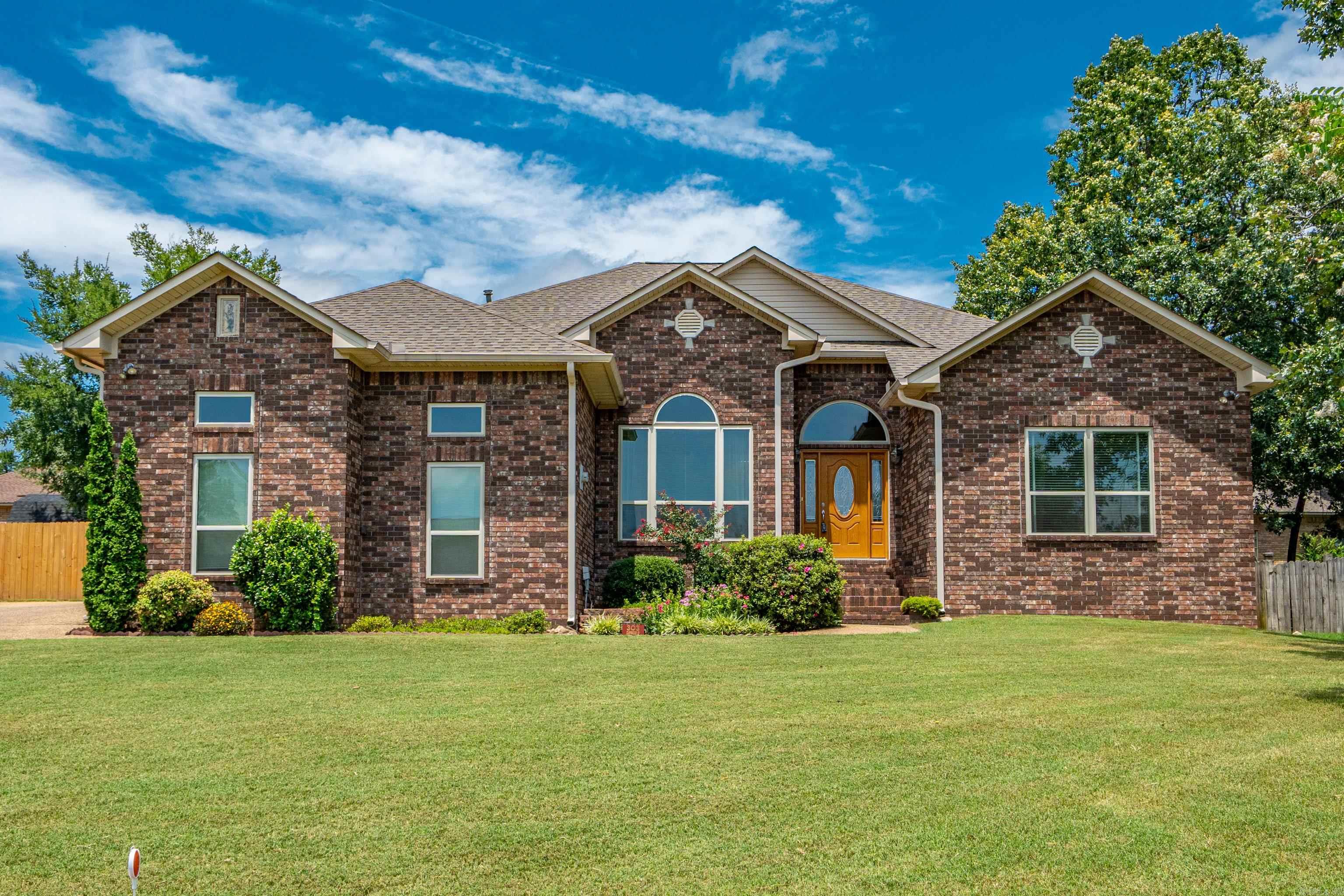 THIS LOVELY FAMILY HOME IS "LIKE NEW"! LAKE ACCESS + 4 BEDROOMS 2 BATHS IN LAKE HAMILTON SCHOOL DISTRICT. A beautifully maintained home that is open, light and bright with transom windows & skylights and newer windows throughout and offers a Large Dining Room and Living Area with a Fireplace and Built-In Cabinetry, an Oversized Kitchen with Pantry + Stainless Appliances and Gas Stove, a Breakfast Bar + Breakfast Nook. All bedrooms are one one level of the home and the Master Suite is sequestered with a large bedroom, an updated bathroom, and spacious walk-in closet! Outdoor you will enjoy a covered patio, recently new privacy fencing, a great custom built storage building, and beautiful landscaping. The neighborhood provides a great area to walk and this location offers easy access to schools, shopping, restaurants and medical providers. The roof and heat/air were replaced in 2024, the paint is fresh and this home is a PLEASURE to show!
