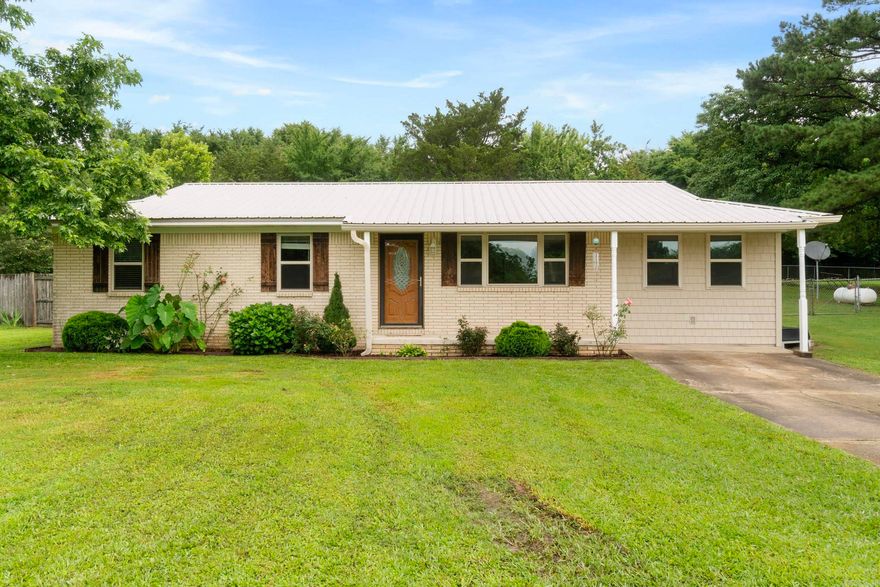 Tired of city noise and tiny yards? Come home to peace, space, and that country feel you've been craving! This sweet starter home is built on a slab and is situated outside city limits on a +/- 0.75-acre lot. With 3 cozy bedrooms, a beautifully remodeled bathroom with a dual vanity, and a BONUS area that's ideal for a playroom, home office, or a second living space - this move-in ready home is as functional as it is welcoming. This cozy kitchen has plenty of space to cook, gather, and make memories - whether it's weeknight dinners or baking cookies with the kids. With a metal roof overhead and updates throughout, all the hard work has been done for you. Outside, you'll immediately see what sets this home apart - a LARGE front yard that's perfect for front porch sitting and sweet tea sipping! Don't forget the spacious fenced-in back yard - There's MEGA space for your pets to roam, the kids to pay all the sports/activities, and you to breathe a little easier.  Imagine setting up your dream chicken coop, garden, and a fire pit!  Gutters! Security system! All windows replaced by previous owner. Sq. Footage approx. Pls measure. This property is very special and has been well-maintained.