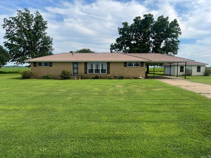 Your Perfect Country Escape Awaits! Spacious 2-Bed, 2-Bath Home on 1.19 Acres - 560 E State St, Caraway, AR 72419. Imagine waking up to peaceful rural views, with plenty of room to breathe, garden, or just relax under the wide-open Arkansas sky. This charming 1,600+ sq ft home offers the ideal blend of comfort and country living - just outside the friendly small town of Caraway, yet only a quick 30-minute drive to all the shopping, dining, and excitement of Jonesboro! Step inside to a bright, open layout flooded with natural light. The huge dining room is perfect for family dinners, holiday gatherings, or entertaining friends - it'll quickly become the heart of your home. Both bedrooms are generously sized for ultimate relaxation, and the two full bathrooms make mornings a breeze. Outside, the magic really shines: 1.19 acres of your own private land - space for kids/pets to play, a garden, chickens, or whatever your heart desires! A versatile storage building/workshop ready for your hobbies, tools, projects, or extra storage. A built-in storm shelter for total peace of mind during those Arkansas weather days.