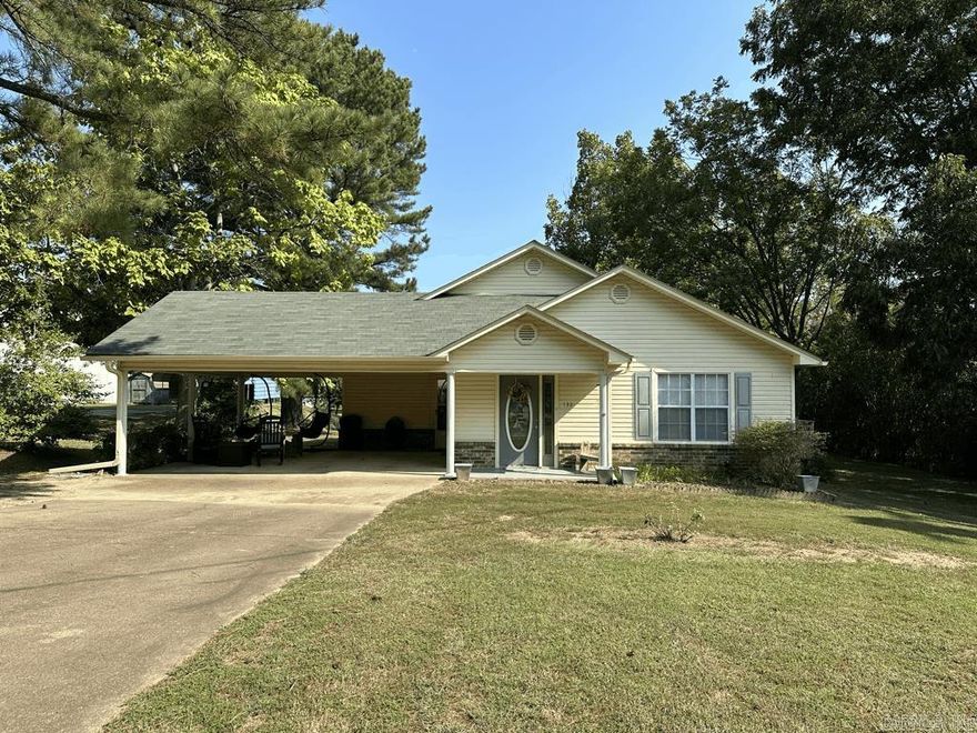 Neat and clean.  Right in the heart of Mt Ida, AR is this 1472 sq ft 2 bedroom 2 bath.  Brick and vinyl exterior.  Beautiful crape myrtles, huge pine tree, 2 pecan trees, 3 apple trees, a fig tree, and the back fence is filled with muscadines.  The carport is large enough to park a car and have a covered outside sitting area.  Inside is neat and clean. Laminate plank flooring in living room, spacious kitchen, and nice sized laundry room.  Central heat and air.  2 storage buildings included.  All this sitting on 0.48 acres.  Move in ready.