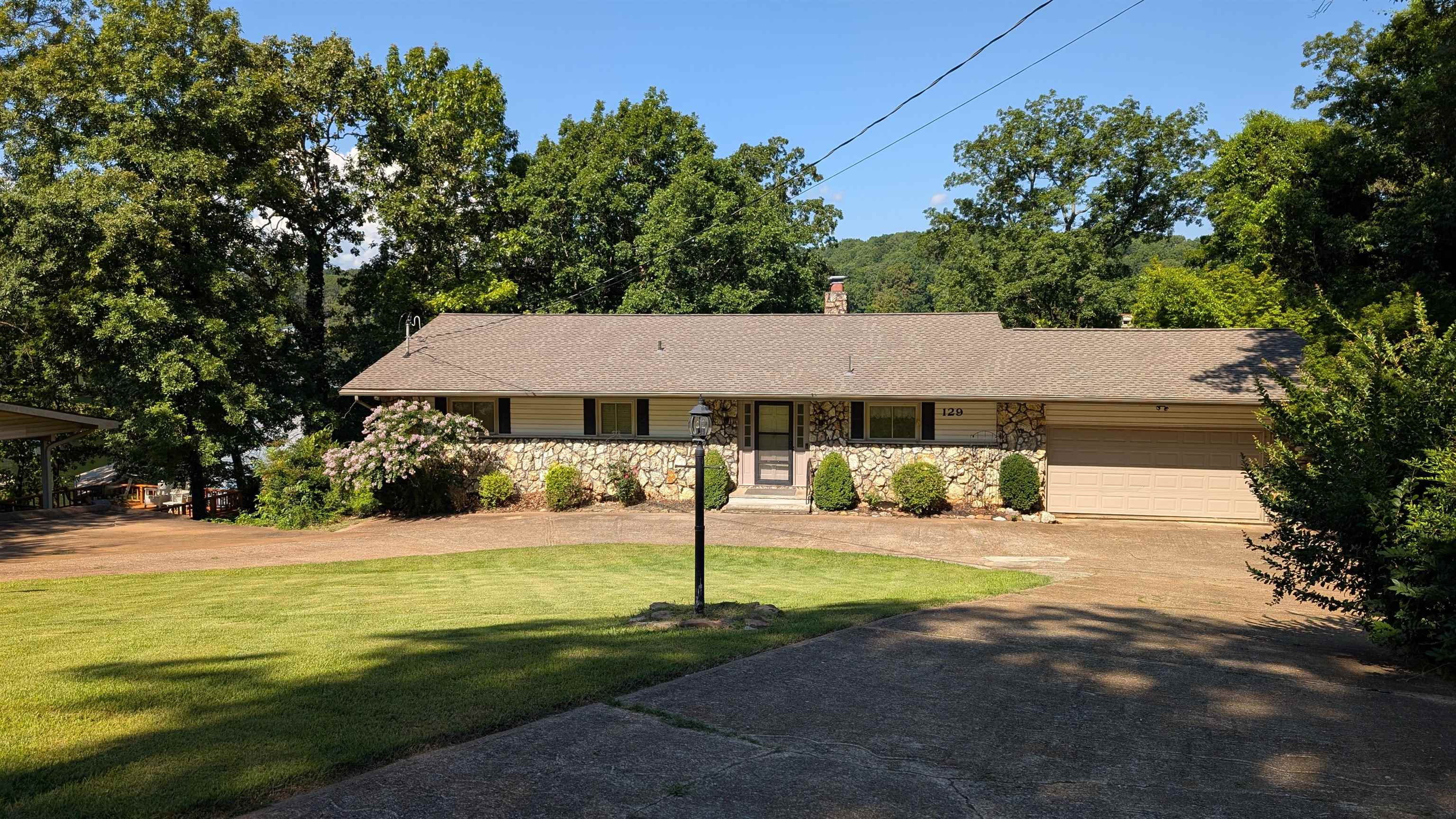 Lake Thunderbird - prime location for Fireworks viewing just down from the marina and dam. Conveniently located less than 1/2 mile from DG, Carol's lakeview restaurant. Only a few blocks to 2 other lakes for more fishing & boating. Updated roof, HVAC & state of the art septic system. Main level includes 2 bdr, 2ba, living/dining/kitchen and walk out to deck or 2 car garage. Circle drive and extra parking means plenty of guests or family can visit! Lower level has 2 more bdrs, another bath, plus family rm & 2 more areas for crafts, sewing or home school. More storage outside with your shed and a nice pack from the garage all the way to the dock so you don't have to lift your cooler. All electric home with 2 units for zoned/energy efficiency plus 2 fireplaces (one w/insert)-1 on each level. List price incl all appliances: stove, microwave, fridge, dw, w/d several of which are recently updated. Although the seller has made every effort to maintain the home, it does need some cosmetic updates, especially in the basement. Make an appointment today to see the home in person!