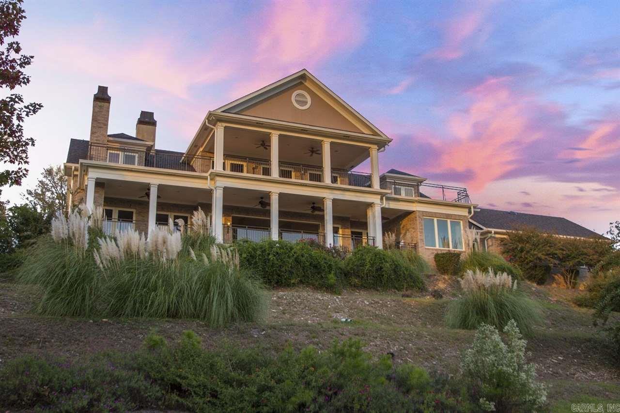 From the gated entry enjoy the private drive up to this stately home with Panoramic views from the ridge top. fantastic views from ceiling to floor glass walls. Kitchen has granite counters tops, gas cooktop and every other amenity you would want. Formal dining, office, guest bedroom and bath on main level.Den with fireplace off the greatroom has fireplace #2 and is open to the kitchen & breakfast area. 2 covered porches with beautiful views, bonus room downstairs and elevator to all  floors.