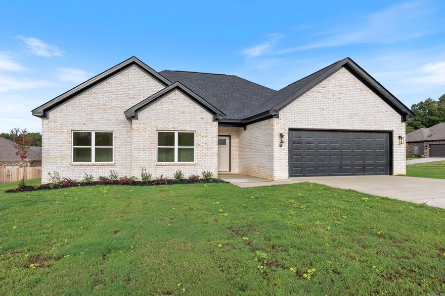 SELLER OFFERING $4000 BUILDER'S CREDIT! Stunning new all-brick home with striking white brick and black finishes on a corner lot in Lewis Cove Subdivision! Located directly across from Wooster Elementary, this new construction showcases modern style and thoughtful details throughout. Highlights include an electric fireplace with custom trim work, an accent wall in the primary suite, and a spa-inspired bath with a large soaking tub, tiled walk-in shower, and spacious primary closet. The kitchen offers a pantry, while the laundry room features custom cabinetry and built-in lockers for a mudroom area. Additional features include an insulated garage door, covered back patio, and the convenience of fiber internet access. Builder offering a one year builders warranty.