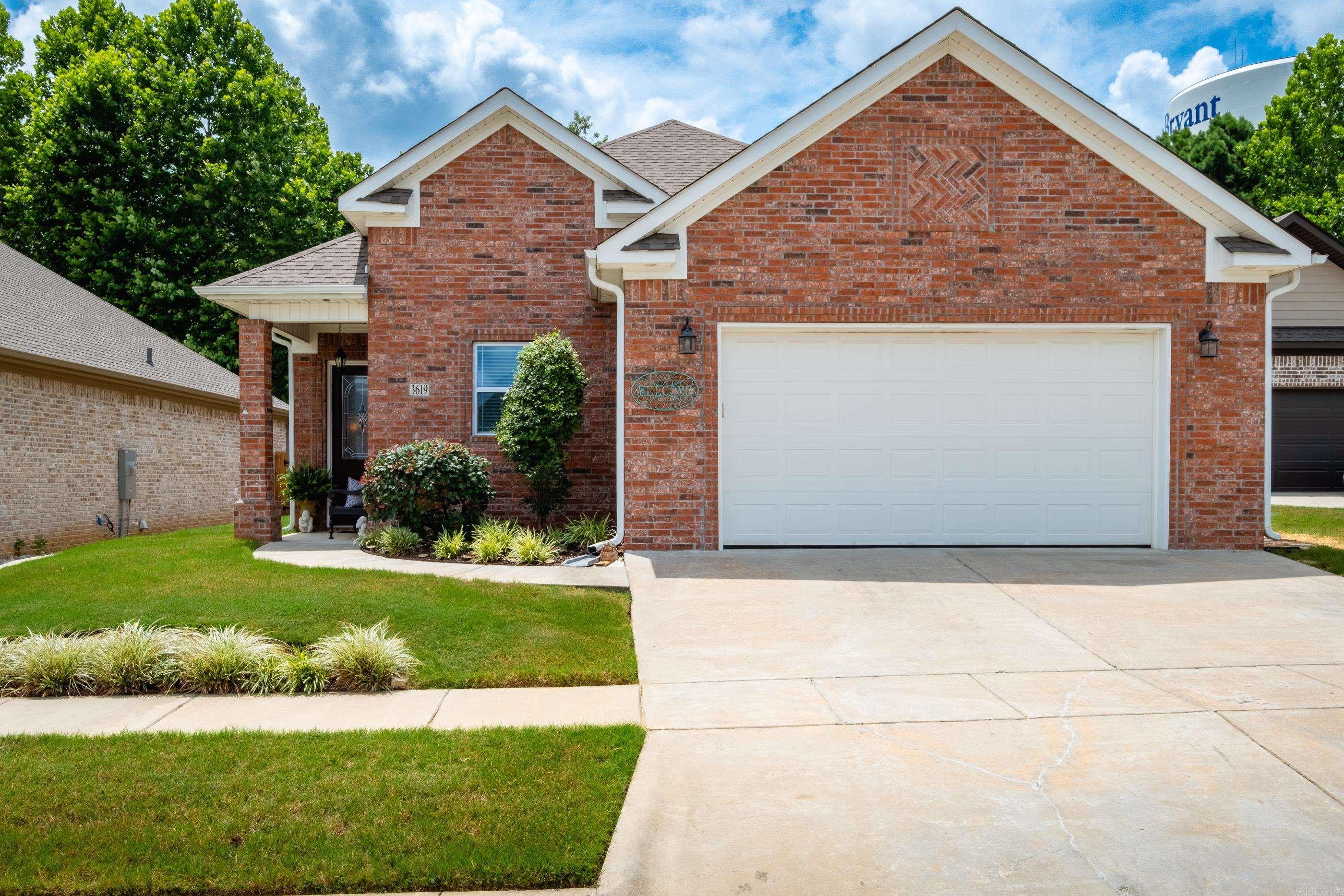 This meticulously cared for, one story home in a gated community was once the model home for the neighborhood, so it has lots of extras. Spacious kitchen with island, granite counters, soft close drawers, stainless steel appliances including a new microwave in 2023, and a built-in desk area. Ten foot ceilings and 8 foot doors throughout the home make it feel even more open and spacious. Beautiful hardwood floors throughout the main living space. Living room has a peaceful view of trees and a fireplace with gas logs. Surround sound throughout. Spacious bathrooms include a 6 foot tub in the guest bathroom and a walk-in large shower in the primary bath. Additional features include a Storm Shelter, walk up attic space with storage and energy efficient foam insulation. Private backyard that backs to green space has a covered porch, and storage building. Convenient access to shopping, restaurants, and easy interstate access. Agents, see remarks.