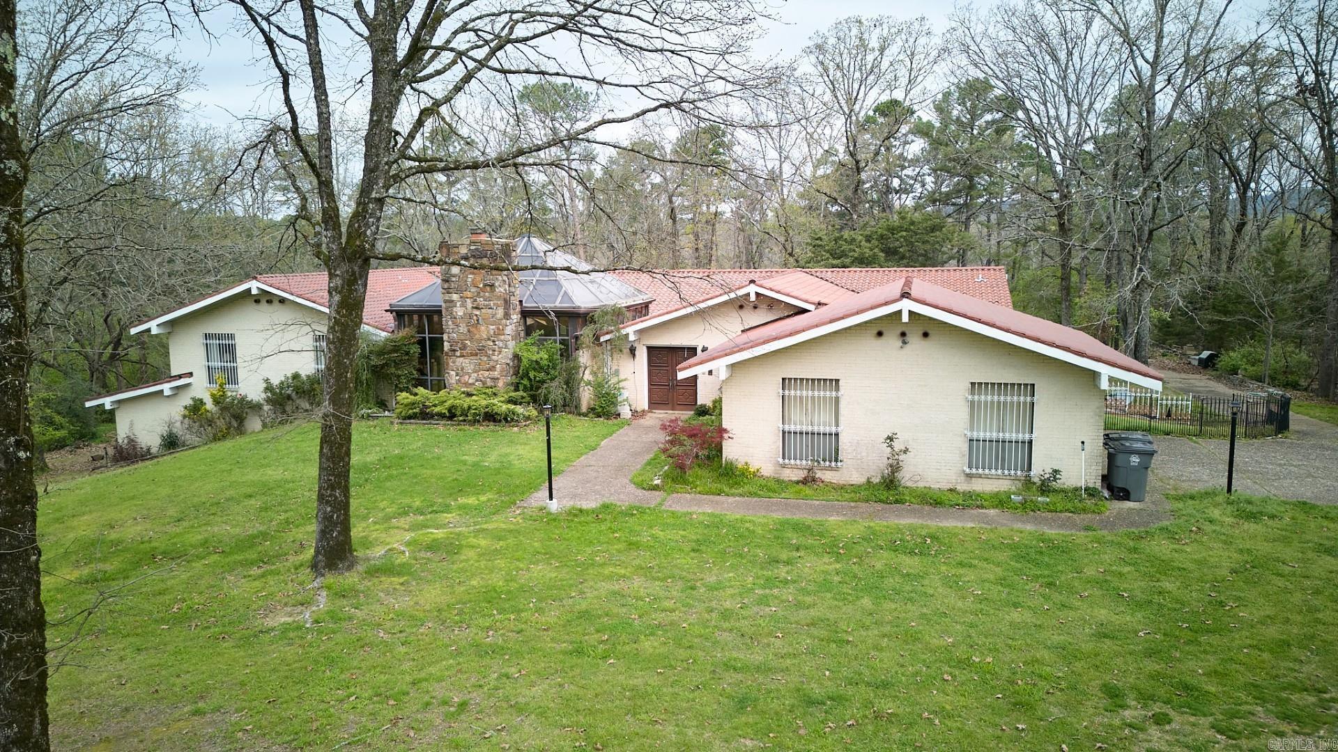 Wonderful Spanish Style home on one of nicest lots in beautiful Eastgate II. Winter garden/Atrium with wood-burning fireplace and soothing fountain is lovely. Primary and two guest rooms on main level. In addition to Formal Living and Dining there is a marvelous Study. Downstairs is a Recreation Room with wet-bar, two bedrooms and baths and several other rooms to make workout room, sewing room, craft room. There is an outside access workshop room also. The yard has defined areas for walking and gardening. There is also a greenhouse room off the main level kitchen. Work is needed to restore this home to itās former glory, but Seller has reflected this in the listing price.