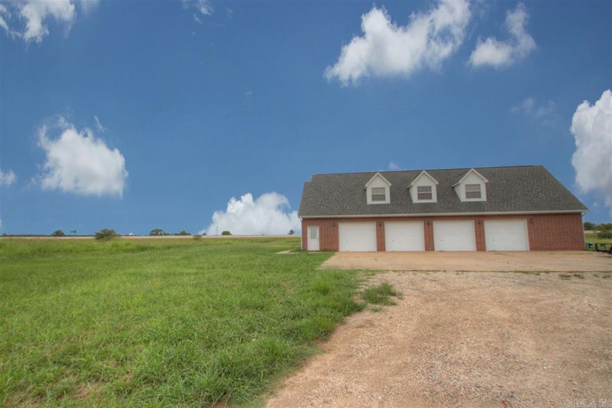 This property features approximately 60 acres, and a brick home featuring 4 garage doors and large 1 bedroom loft style home above with 1.5 baths.  It has laundry & workshop area in addition to the ample storage provided by the 4 car garage.  This property is conveniently located .1 miles from Texarkana AR city limits with easy access to I-49, so convenient to everywhere.