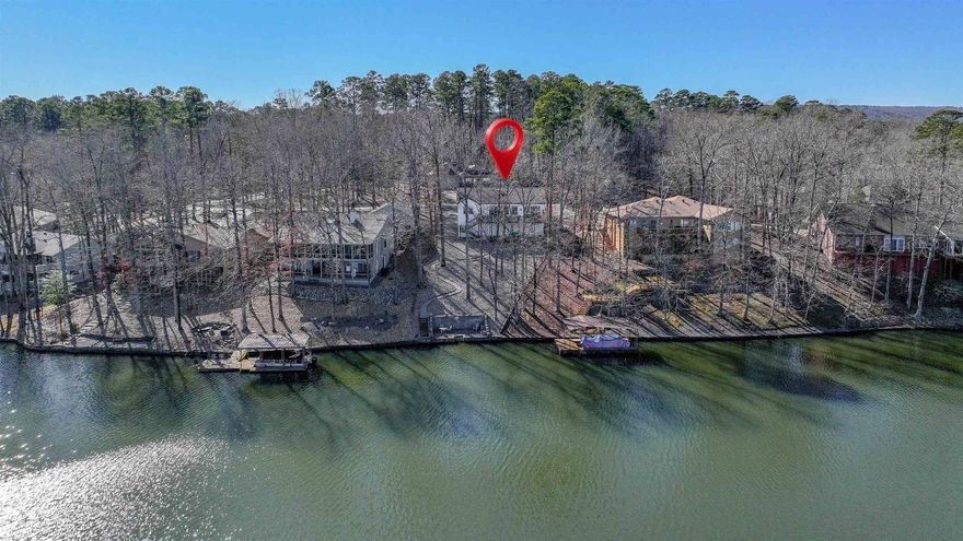 Wow! Rare Find! Newer Construction on the Lake! Check out this 2017, Tucker Omohundro Custom-Built Home with Amazing Waterfront on 245-acre recreational Lake Cortez! Start your mornings with a cup of coffee enjoying sunrises from the deck overlooking spectacular lake views.  Delight in the lake views from nearly every room in this One Level, Split Bedroom Floorplan! This Home boasts a Level Driveway, 9’ Ceilings, Rounded Corners, Luxury Vinyl Plank Flooring, and a Gas Fireplace w/Granite Tiles! Enjoy the Kitchen Eating Bar with Glass Tile Backsplash, Gas Stove, Under-Cabinet LED Lighting & Large Pantry! A Double Slider opens to the 400+ sq. ft. Composite Deck overlooking the Lake – Perfect for BBQ/Entertaining! 2nd custom built lakeside block/stone deck with 4ft. wide steps leading into the lake for easy access to water play! The Owner’s Suite offers its own Slider to the Deck/Water View, and an Ensuite with Tile Floor, Walk-In Closet and a Gorgeous Oversized Tile Shower! Turn-key! MOST OF THE FURNITURE INCLUDED!. SAVE $ Every Month with the $20k+ Solar System that keeps the Electric Bill UNDER $100 per month!!! 26,000 Gated Acre Hot Springs Village offers 11 Lakes/9 Golf Courses!