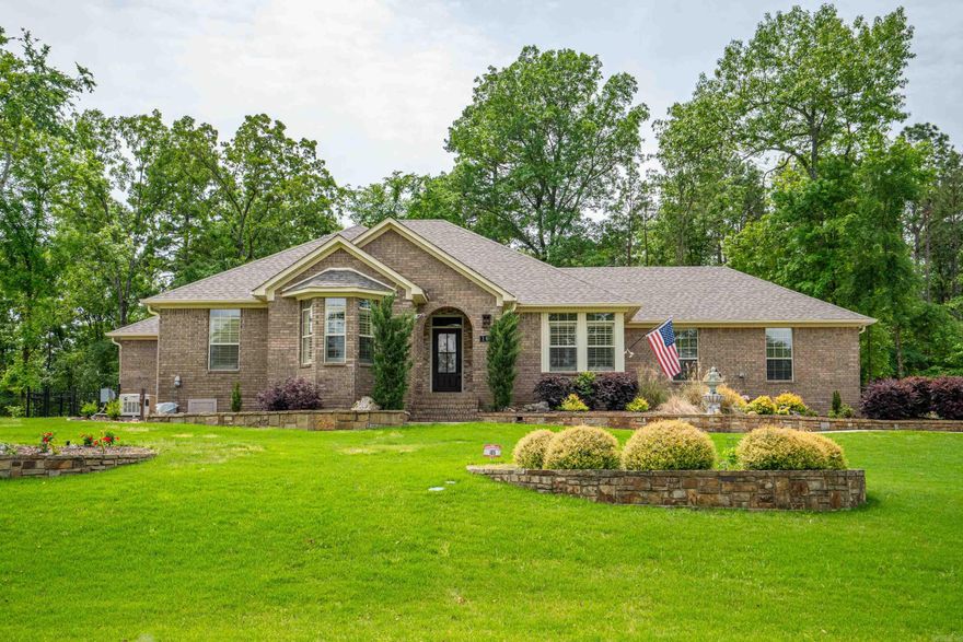 TURTLE BAY AT DRIFTWOOD provides a lovely setting for this 2600 SF residence with 3 Bedrooms 2 Baths + LAKE ACCESS for your pleasure.  This IMMACULATE + TASTEFUL home offers a spacious entry to a large Dining Area with Lake Hamilton views - to an adjoining Kitchen with quartz countertops, and a Banquette Breakfast Nook.  An Open Living Area offers built in cabinetry and a pretty gas log fireplace.  The Guest Bath has been recently updated, as well as the Master Bathroom Ensuite.  A fantastic part of this home includes a large Arkansas Room surrounded with windows for views of the forest and wildlife - or enjoying your favorite sports!  Recent addition to this property also provides wrought iron fencing in the back for your furry friends.  A whole-house generator ensures no loss of comfort!
