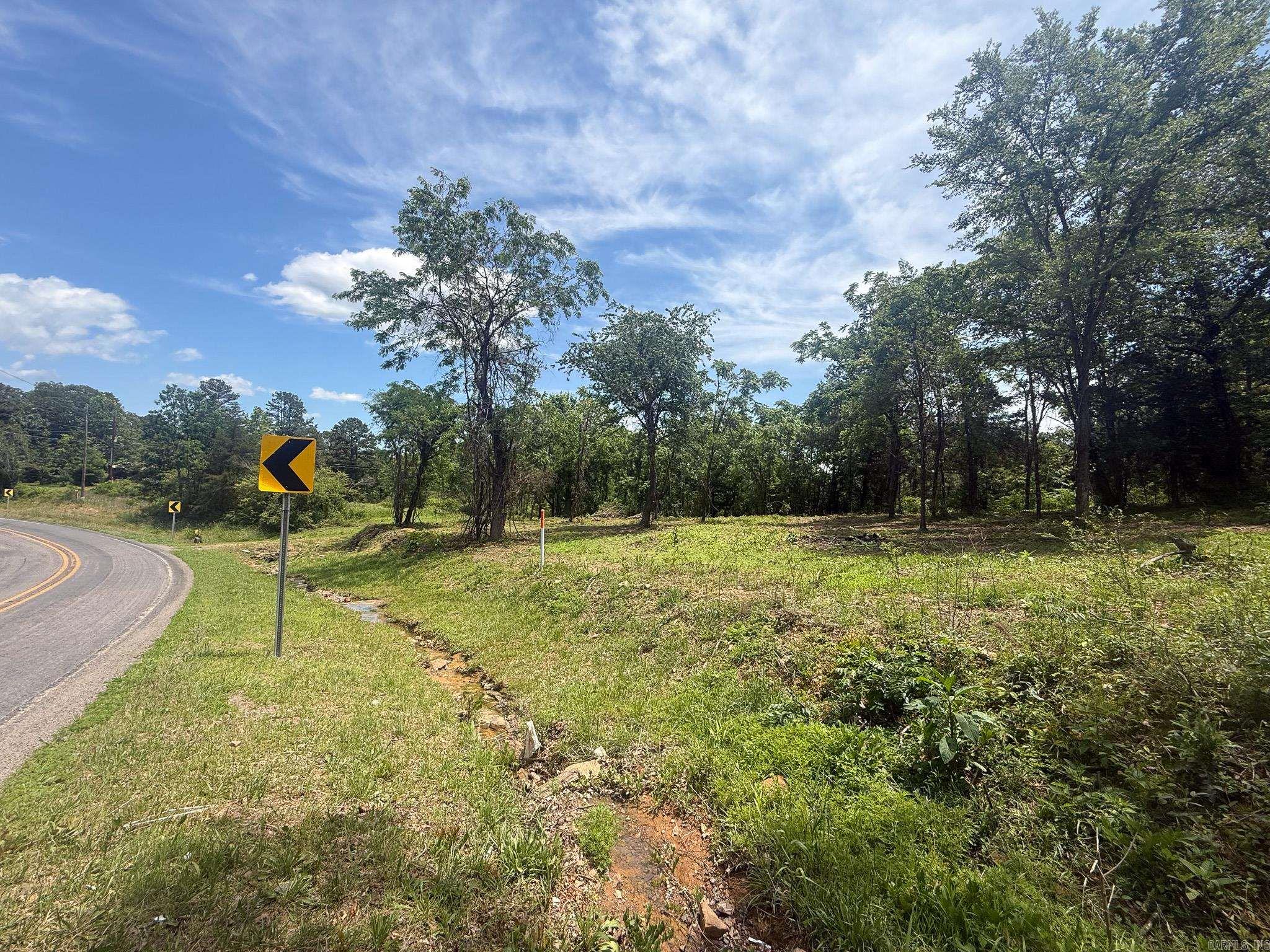 Stunning Acreage Near Fairfield Bay – No HOA! Discover the perfect blend of privacy and convenience with this beautiful piece of land located just outside the city limits of Fairfield Bay. Situated only minutes from the marina, golf course, hiking trails, and all the amenities Fairfield Bay has to offer—yet with no HOA restrictions—this property gives you the freedom to bring your vision to life. Backed by the breathtaking Williams Rocks, this land offers incredible natural beauty, stunning views, and a peaceful setting. Whether you're dreaming of a cozy homestead, a weekend getaway, or your own private escape, this land is ready for whatever you have planned. Utilities nearby. Build when you’re ready—no timeline, no pressure. Come explore the possibilities today!