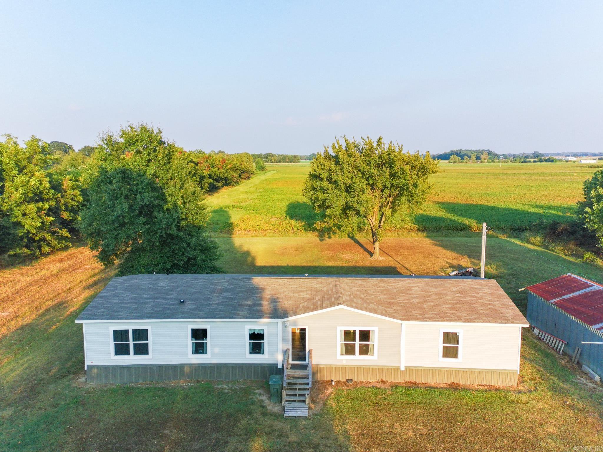 Discover this inviting 4-bedroom, 2-bathroom home on a 1-acre lot in Trumann, AR. Spanning 2,128 square feet, this move-in-ready gem features an open-concept living area flowing into a modern kitchen with stainless steel appliances, ample cabinetry, and a breakfast bar. The primary suite offers a tranquil retreat with an en-suite bathroom and walk-in closet, while three additional bedrooms provide space for family, guests, or a home office. Enjoy a spacious backyard, ideal for gatherings or play. And, a workshop with power - perfect for parking, tinkering, and storage. Nestled in the desirable Trumann School District, you're close to parks, amenities, and Highway 69 or I555 for easy commutes to Jonesboro. Schedule your tour today and embrace small-town charm with room to grow!