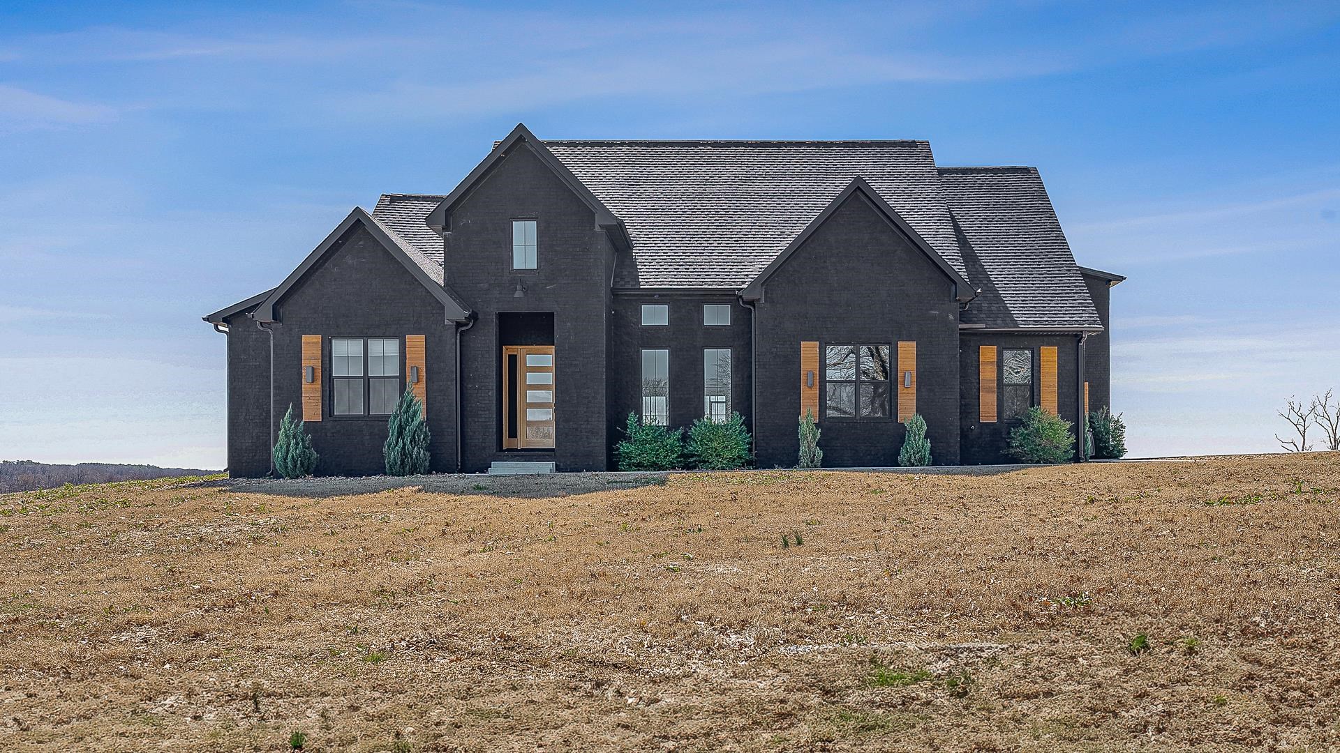 Discover this stunning 4-bedroom, 3.5-bathroom home, built in 2022, offering a perfect blend of modern design and exceptional craftsmanship. Featuring a unique all-black brick exterior, this property stands out with its bold, contemporary aesthetic. Nestled on 3 acres of serene land just outside the city, enjoy the tranquility and privacy while still being close to urban amenities. With spacious interiors, high-end finishes, and expansive outdoor space, this home is perfect for those seeking a luxurious and peaceful retreat.