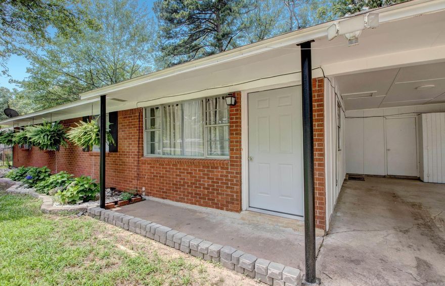 Such an adorable house that's had lots of updates.  Roof is approximately 5 years old plus flooring and painting within the last couple of years.  Kitchen opens to spacious living area giving the homes two living spaces.  Great layout.  Huge backyard with an in-ground storm shelter.  Plenty of room to add on, have big backyard gatherings and more.  Storage off carport.  Home is located within walking distance to school.