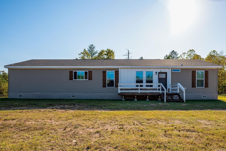 This stunning 2023 modular home is nestled in a peaceful country setting, perfect for those seeking tranquility while being just 10 minutes from shopping, schools, and restaurants. Offering 4 spacious bedrooms and 3 beautifully designed bathrooms, this home combines modern comfort with rural charm. The primary suite features a huge bath with an oversized tub and walk-in shower, providing a luxurious retreat. The kitchen is a chef's dream with ample counter space, and a stylish design that makes it the heart of the home. Large energy-efficient windows fill the space with natural light while keeping the home comfortable and sustainable year-round. Outside, the property boast a 3,000 sq. ft. barn with an additional 3,000 sq. ft. of outside storage, ideal for horses. The land is fenced and cross-fenced, providing security and versatility for livestock. This 10-acre farm is a perfect blend of modern living and rural beauty, offering both convenience and a peaceful, spacious life. Different purchase options available-- Land Only (11 acres) MLS# 25002578 and House & 21 acres MLS# 24037355