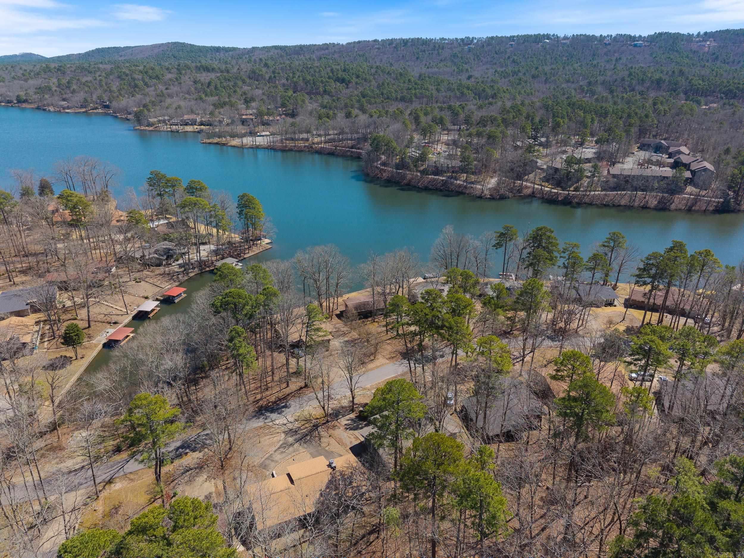 Motivated Seller, bring your offer! This recently remodeled, 3-bedroom Hot Springs Village next to Lake Desoto offers expansive living spaces both indoors and outdoors, featuring a covered back patio! With its vaulted ceilings in the living room, carport, workshop, and ample storage, this single-story home has everything you need. The extended front porch provides a lovely view of Lake DeSoto. Plus, it's just minutes away from all the West Gate amenities, including golf, trails, lakes, marina, swimming beach, and more! Schedule a showing today!