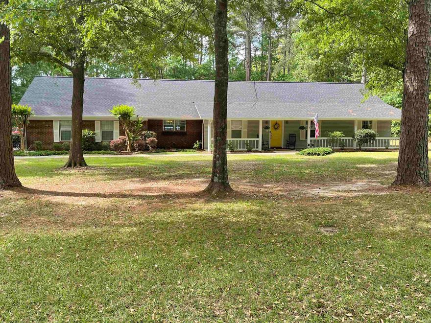 This beautifully updated home offers 4 bedrooms and 3 bathrooms, combining comfort with modern style.  The heart of the home is the large kitchen featuring granite countertops, double ovens, all opening into an expansive eating area perfect for gatherings and adjacent to a spacious family room with a cozy fireplace. You will find abundant storage throughout, along with the convenience of a double garage. Outside, the property continues to impress with a covered porch for lounging and watching tv, large shop, an additional smaller shop ideal as a "she shed" and a fenced inground pool complete with its own pool house and half bath, creating the perfect setup for both relaxation and private entertaining while surrounded by mature trees on each side of the 3.20 acres.