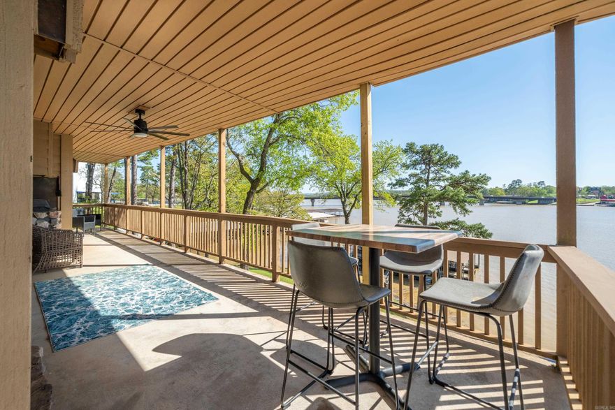Wake up to beautiful lake views in this updated water front condo! Enjoy your coffee or dinner on a private balcony with nothing obstructing your view of Lake Hamilton. In a gated complex, inside you will find a cozy living space filled with natural light. Newly remodeled in 2023-2024, with automatic blinds throughout, a wet bar, gas fireplace, HVAC-4 years old, built in outdoor grill, storage unit, and new roof in 2024. Included is a covered boat slip with a newly installed Tritoon boat lift. You have designated parking in a 2 car covered carport with a swimming pool and clubhouse in the complex.  So convenient to shops, restaurants, Oaklawn and so many fun things in Hot Springs as well as a great location on the lake! Perfect for a full-time residence or a weekend getaway! See agent remarks.