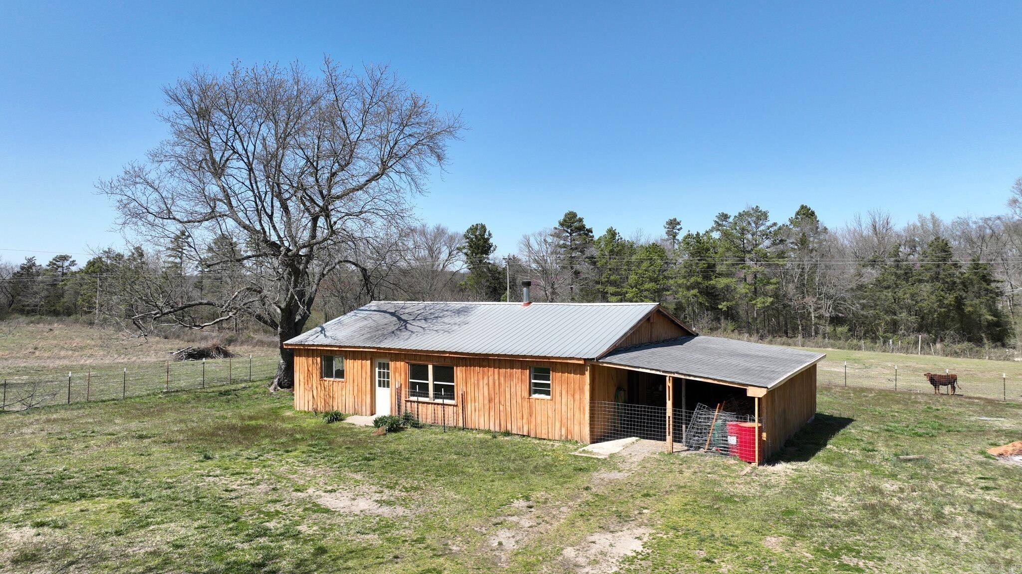 Charming Country Cabin on Nearly an Acre! Looking for a cozy retreat with great potential? This 3-bedroom, 2-bathroom country cabin sits on 0.96 acres of fully fenced land, recently surveyed for accuracy. With some remodeling already completed, updated bathrooms, new siding, and a brand-new septic system, this home is well on its way to becoming the perfect getaway or investment property. While it still needs some finishing touches, this home offers plenty of opportunity to make it your own. Whether you're looking for a rental, a fixer-upper project, or your own escape, this property is full of possibilities. Easement to the property and home is currently on a shared well. Sold "AS IS"