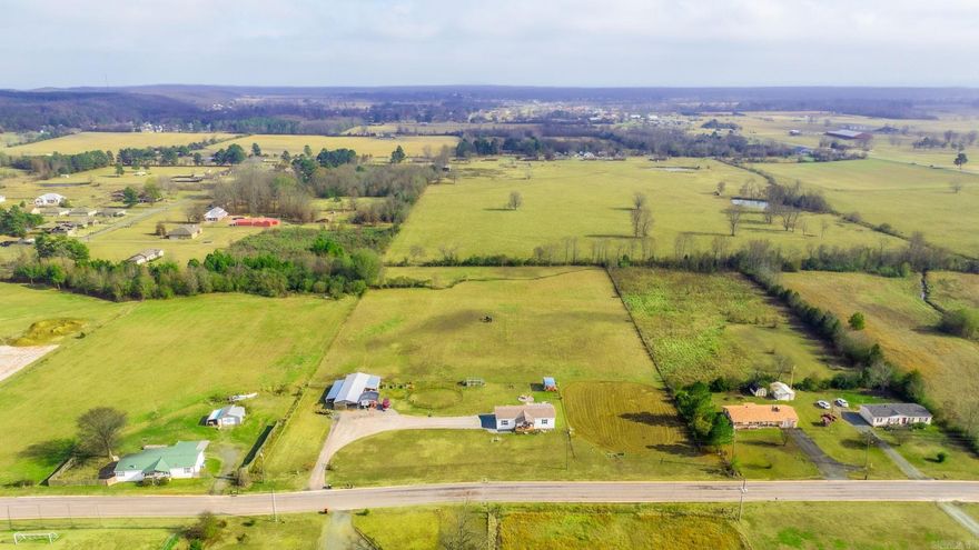 Looking for space to have horses? This property is a rare find. This almost 7-acre meticulous maintained piece of land with has a pole barn, covered RV parking, storage buildings and a practice arena with lights. Fully fenced and ready to go. Enjoy evenings on an oversized patio, deck. Back yard also features a firepit. The almost new modular home is on a permanent foundation and has an open concept with 3 bedrooms and two baths.  Panels in round pen do not convey