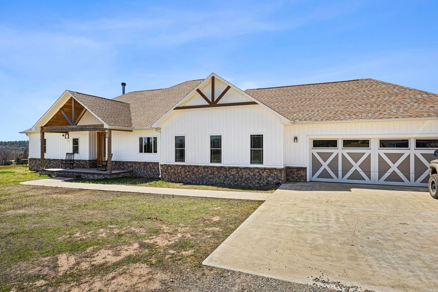 Dreaming of space, privacy, and land you can actually enjoy? This custom-built home on 30.83 acres is what you need! With a mix of open pastures and natural areas, there’s plenty of room to spread out, explore, and create the lifestyle you’ve been imagining. Built in 2021, the home thoughtfully blends modern comfort with a connection to the surrounding land. Inside, the 4-bedroom, 2.5-bath split floor plan is designed for both everyday living and entertaining. Soaring ceilings, an open layout, and quality finishes throughout make the space feel bright and welcoming. Outside, the 40x80 shop is perfect for hobbies, business, or equipment storage, and solar panels provide energy efficiency and long-term savings. Properties that combine a newer custom home, usable acreage, and functional infrastructure are hard to find. Located 15 minutes from Ozark and about 40 minutes from Fort Smith, this property offers the freedom of land ownership without giving up convenience - an ideal setting to live, work, and play.