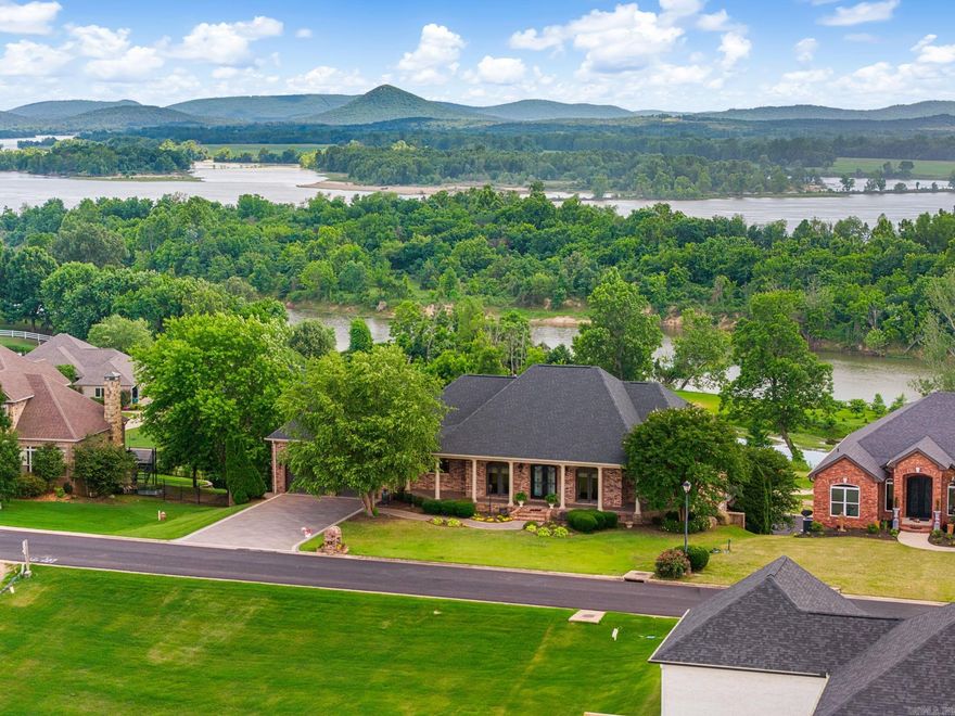 Welcome to this exceptional home with wide angle views of both the Arkansas River and Pinnacle and Chenal Mtns. The Primary suite and additional BR are on the main floor, as is the expansive living room with extra large new windows, a large kitchen, dining room, breakfast room and beautiful powder room.  The walk in pantry, oversized garage, screened-in porch and sunning deck are also on the main floor.  Down stairs are 2 additional BRs, a game room with bar, a full bath and access to the stunning salt water pool.  Step outside and you will find not only the sparkling pool, but plenty of sitting areas and an outdoor fireplace.  Below the fenced yard, there is a 30x35 foot separate garage/shop for a boat, a sports car or lots of toys!! This home is geo thermal, has a tankless water heater and whole home generator!!! Kroger 9.7 mi, Harps 5.9 mi, Lumber One 4.8 mi, Walmart 11.0 mi, gas station 5.0 mi, Sonic 5.5 mi, downtown LR 22.0 mi, Smoke Shack BBQ 7.5 mi
