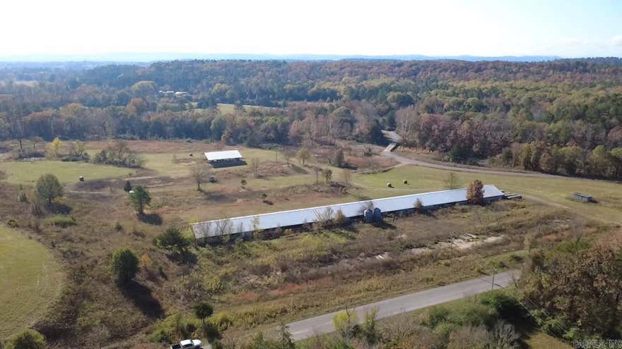 3-bedroom, 2-bath 1993 mobile home offering approximately 1,196 sq ft, set on about 33.5 acres with a versatile collection of improvements. The property includes roughly 900± feet of Brushy Creek frontage, a 56×60 pole shed, 26×24 carport, 10×20 storage shed, and an additional 8×10 storage building. There are three wells, a small pond, and several fruit trees on site. Located about 1 mile from the Ouachita National Forest and approximately 3 miles from the Ouachita River. No restrictions, providing flexibility for a variety of uses.