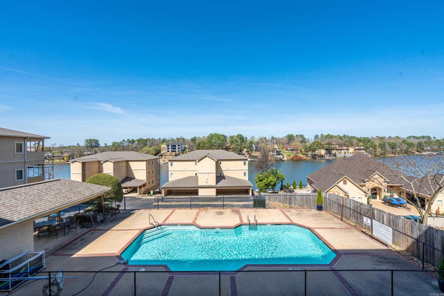 When you step into this 7 South Lookout Point Condo you will enjoy the perfect blend of comfort, convenience, and lakefront living in a spacious 1,520 SF, 2-bedroom, 2-bath ground-floor unit on Lake Hamilton. Designed for easy living, this zero-step unit means no stairs, no hassle—just a smooth transition from your car to relaxation mode. The open, inviting layout is complemented by stunning lake views and a front-row seat overlooking the pool, because let’s be honest… a good view never goes out of style. A full-width balcony stretches across the condo with access from both the living room and primary bedroom—perfect for morning coffee, evening unwinding, or simply reminding yourself why you chose lake life in the first place. Located within a gated community, you’ll enjoy added privacy, a scenic boardwalk for leisurely strolls, and exterior storage for all the extras that come with living your best life. Low-maintenance, well-appointed, and move-in ready, this condo delivers exactly what it promises—great views, easy living, and just enough charm to make you wonder why you didn’t move sooner.