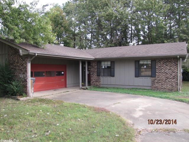 1342 Sq Ft home in established neighborhood needs repairs but has great potential. Vaulted ceiling living room with wbfp opens to a large wood deck looking over the private backyard. Rich laminate flooring in common areas and bedrooms, tile in the kitchen, dining room and baths. Side entry two car garage. Rustic wood exterior.