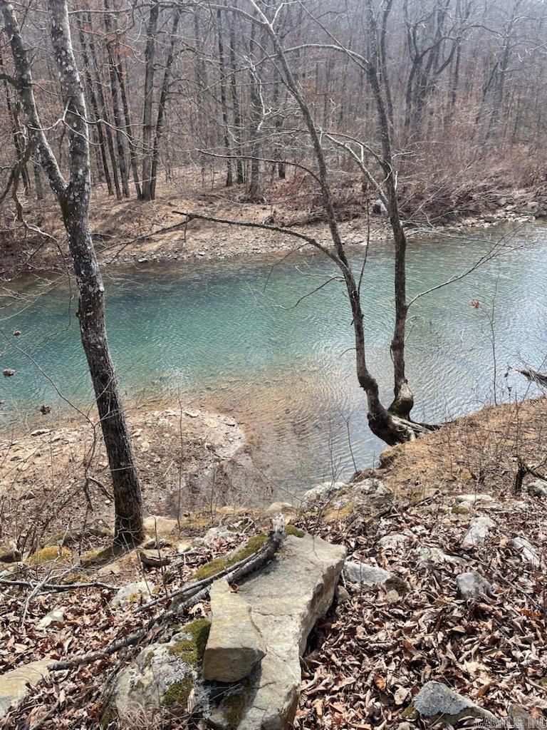 Beautiful Retreat in the Ozarks with 443.26 acres m/l with the Little Red River flowing thru it. Very secluded with a nice 2 bedroom cabin built around 1980 and a a small travel trailer. Big covered porch. Has drilled well and a very nice metal shop building and sheds. Has a 1000 gallon septic but not hooked up to bathroom yet.All pvc pipe is included that was to be used to hook all plumbing up. Kitchen sink at present only water hooked to house. New 30 gallon water heater that needs to be hooked up. Property has been surveyed. Seller reserves 1/2 acre family cemetery plot with permanent ingress and egress. Minerals do not convey. Hunters paradise and very close to the Ozark National Forest!! Please see showing remarks!!