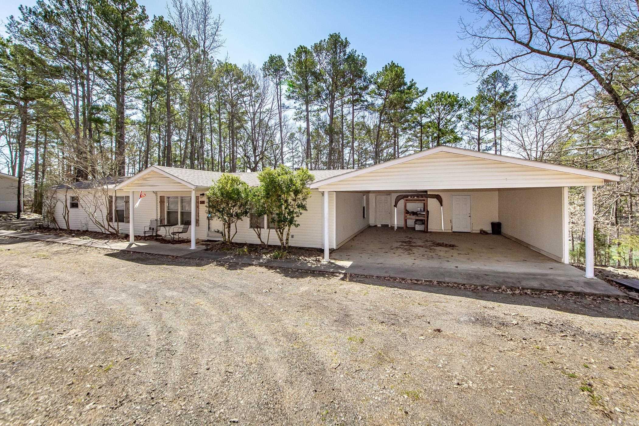 Great lakefront lot with low white line & rock steps in your backyard that lead to an easy walk to the water. Cherokee Park Boat Ramp right around the corner & only 2 miles away. Property has Circle Drive with double wide mobile home that sits on approximately 1 acre of land, two car carport with storage room. New Roof by Rooftec completed in October 2019. Almost all of the furnishings will stay except for some personal pieces (The following items will not stay: White bed in guest bedroom, Brown Wooded bed along with the two matching dressers & nightstand in the 2nd guest bedroom, Dining room table & chairs, and entertainment center in living room by back door). All appliances stay. See Sellers Property Disclosure under "docs" .