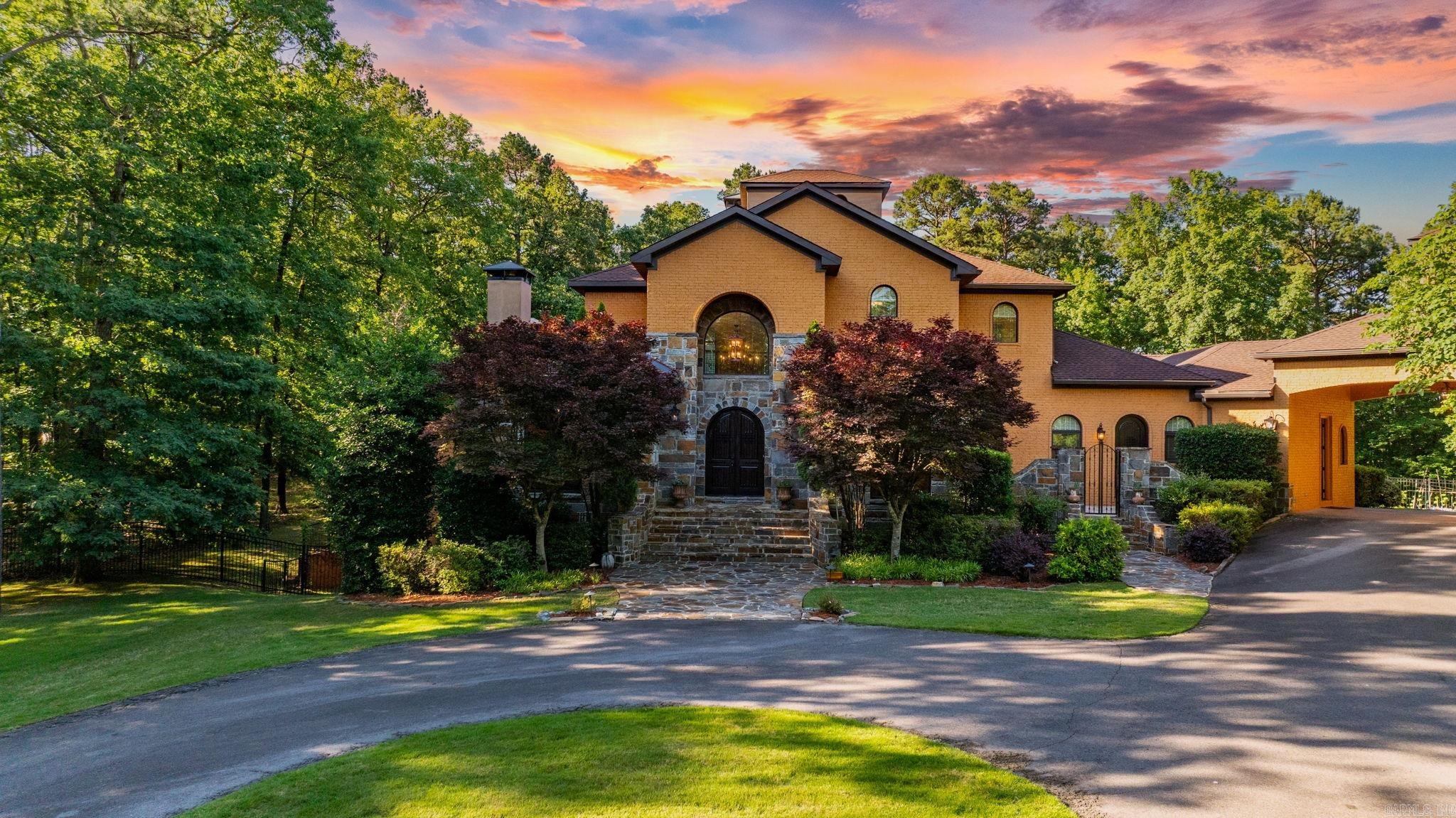 Welcome to this magnificent custom-built 7.76-acre estate nestled within an exclusive gated neighborhood in Chenal Downs, offering unparalleled luxury, style, quality, and privacy. A perfect connection to nature while being conveniently located near shopping, dining, and cultural attractions. This residence features stunning architectural details, exceptional craftsmanship, and premium materials that elevate every aspect of modern living. It boasts a meticulously designed floor plan featuring high-end finishes throughout: spacious living areas, ensuite baths with every bedroom, gourmet kitchen, elegant dining rooms, grand home theater, workout room and amazing outdoor living space complete with patio, swimming pool/hot tub, and outdoor kitchen. The home also features multiple iron doors, 5 fireplaces, 4-car garage, and 3 patios. This remarkable home presents a unique opportunity for buyers seeking luxury features without the high cost associated with custom new constructions. Recent upgrades include: roof 2025, interior paint 2025, standby generator 2024, pool pump 2024, pool heater 2023, EV charger 2022, Sunbrella canopy 2021, gas logs, sealed crawlspace 2018. See agent remarks.