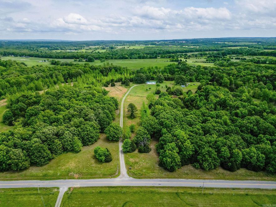 Rare find! This is a beautiful 40 acre private setting with mix of pasture & woods, shop, shed, garden spot and two ponds.  The DWMH is 28x60, 3 bed,2 ba, metal roof, central HVAC but some minor repairs are needed.  The home is being sold as is.