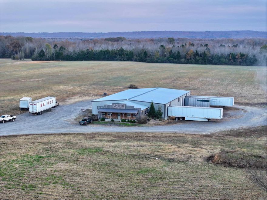 Industrial Warehouse with Office Facilities This expansive 10,467-square-foot warehouse, situated on 18.23 acres, is designed to support diverse industrial operations. The property includes 1,092 square feet of office space, featuring a conference room, kitchen, full bathroom, and a half bath, providing a comfortable environment for administrative tasks. The warehouse is equipped with four loading docks, facilitating efficient logistics and distribution activities. Additional amenities such as paint booths and a storm shelter enhance the property's functionality and safety, making it ideal for manufacturing or large-scale storage requirements. The substantial land area allows for expansion or redevelopment to accommodate retail centers, office complexes, or mixed-use projects. Its proximity to Searcy—a rapidly growing town known for its blend of small-town charm and urban amenities—ensures a steady flow of customers and clients. The presence of Harding University contributes to a vibrant community atmosphere, further enhancing the property's appeal for businesses aiming to capitalize on the local market.