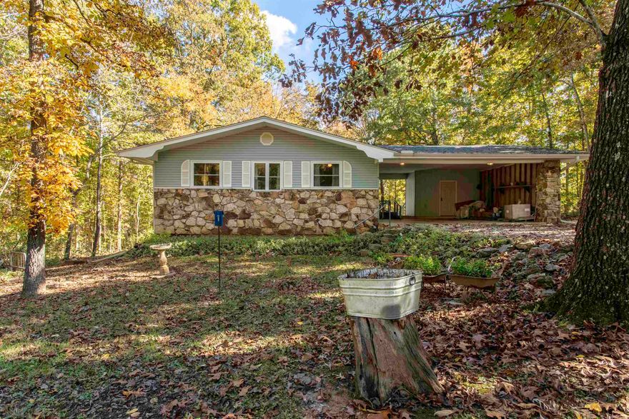 Country Home in the Ozarks Sharp County Arkansas 6 Vagabond Rd. • Williford, AR 72482 Offered at $209,900  Sitting on two lots, this well-kept 2,640 sq ft home offers comfortable multi-level living with room to spread out. The main level features 1,320 sq ft with an open-concept kitchen, dining, and living area, along with 2 bedrooms, 2 full baths, laundry, and an enclosed sunroom overlooking the backyard.  The lower level basement adds another 1,320 sq ft, offering a 3rd bedroom, full bath, spacious living area, and a mechanical room—ideal for guests, multigenerational living, or hobby space.  Recent improvements bring peace of mind, including a new roof and gutters (2023), pellet stove installed in 2021, wood-burning insert on the lower level, Anderson windows, and a 2021 water heater.  A practical layout, solid upgrades, and natural-heat options make this a smart choice for full-time living or a getaway. Outside storage closet and a Morgan storage building.  Ozark acres also has 2 spring fed lakes available for all property owners and a club house. Located near Spring River as well.