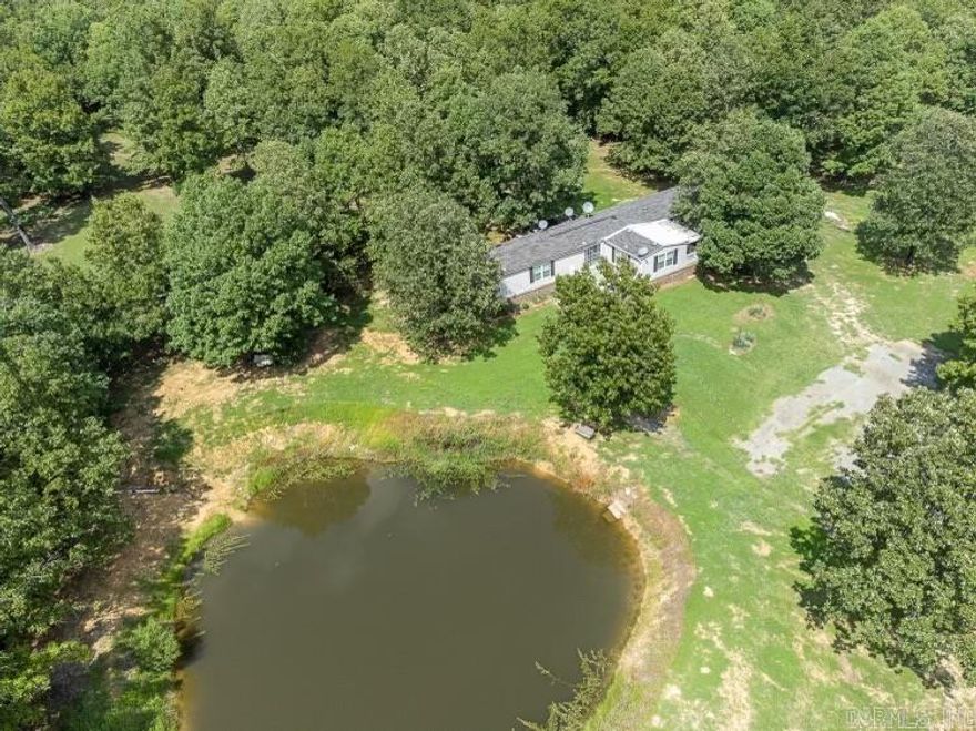 *SOLD AS_IS as reflected in price* This property has been thoughtfully updated and is now ready for you to call home. Nestled on 5.33 acres in Bradford, AR, this charming 3-bedroom, 2-bathroom manufactured home offers 1,440 sqft of comfortable living space, perfect for country living. The expansive, level, and cleared land provides plenty of room to explore and enjoy the outdoors. Inside, the well-designed split floor plan ensures privacy and functionality for all. The spacious open-concept living area seamlessly flows into the kitchen, which features a breakfast bar—ideal for both entertaining and casual dining. The kitchen offers ample cabinet space, perfect for preparing meals and hosting guests. A bonus room adds versatility to the layout, serving as an office, playroom, or additional living space. The private primary suite features a generous en-suite bathroom with a soaking tub, separate shower, and double vanity. Outside, the property truly shines with stunning views from every direction, shade trees for relaxation, and a fully stocked pond for your enjoyment.