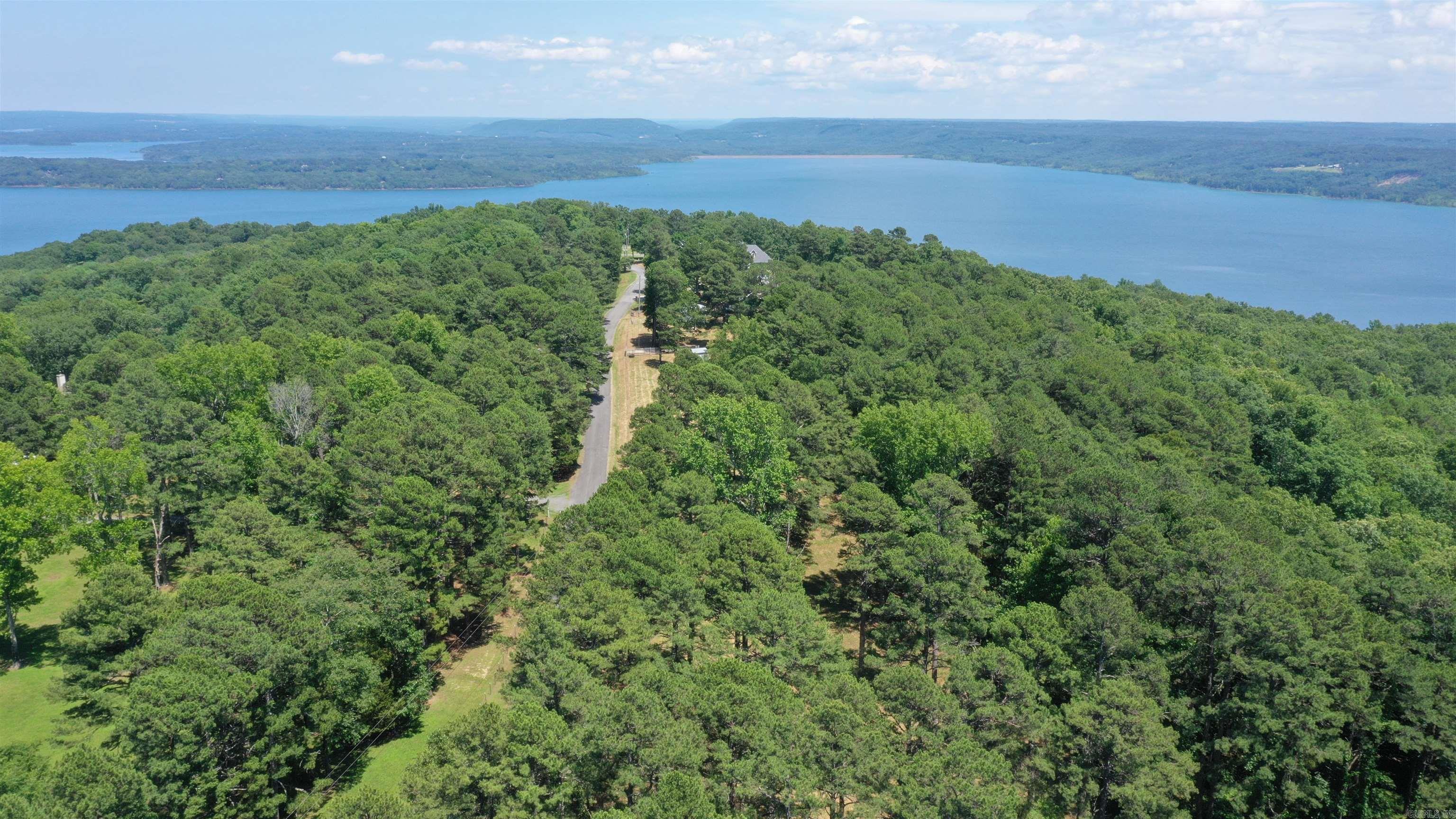 Discover the perfect canvas for your dream home on this 5.65-acre lot overlooking the beauty of Greers Ferry Lake and the surrounding mountains. This property offers a blend of privacy, spectacular views, and easy access to everything you need. Whether you're planning to build a full time residence or a weekend getaway, this lot is ready for you to bring your vision to life. Electricity is already on the property, and water is available at the road. Thereās plenty of room to spread out, and the views truly speak for themselves. If youāve been waiting for the right piece of land, this one is worth a look!Ā See Drone Video!