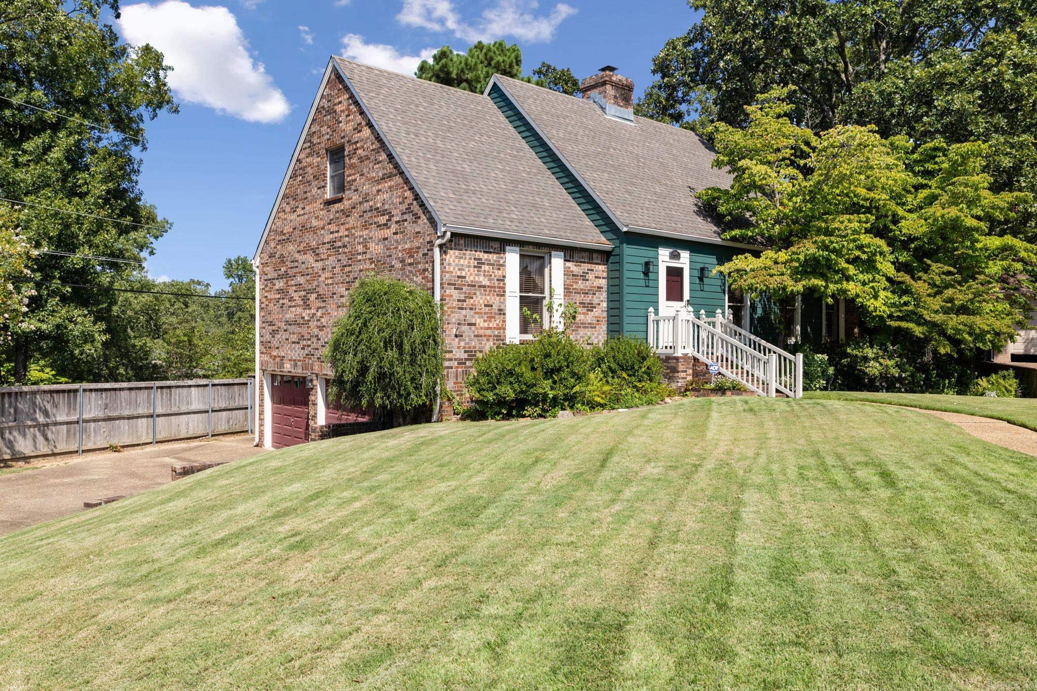 Settle into this beautiful custom-built home in the heart of North Little Rock. Featuring 4 bedrooms, 2.5 bathrooms, and over 2,439 sqft of living space on main levels, and over 500 sqft of additional partially heated and cooled space in the basement, this one-owner property has been lovingly maintained and is ready for its next family. Step inside and be greeted by the warmth of original wood trim and solid wood doors, paired with a true brick, wood-burning fireplace that creates a cozy focal point. The home offers real brick flooring, generous living spaces, and ample storage throughout. Set on a large, beautifully landscaped corner lot, the property provides both privacy and charm. Enjoy quiet mornings or gatherings with friends on the patio, or take advantage of the workshop space in the basement for hobbies, projects, or extra storage. A 2-car garage adds convenience, while the quiet street makes this location ideal for peaceful living. This meticulously cared-for home offers timeless character, thoughtful design, and unbeatable charm—truly a rare find in North Little Rock.