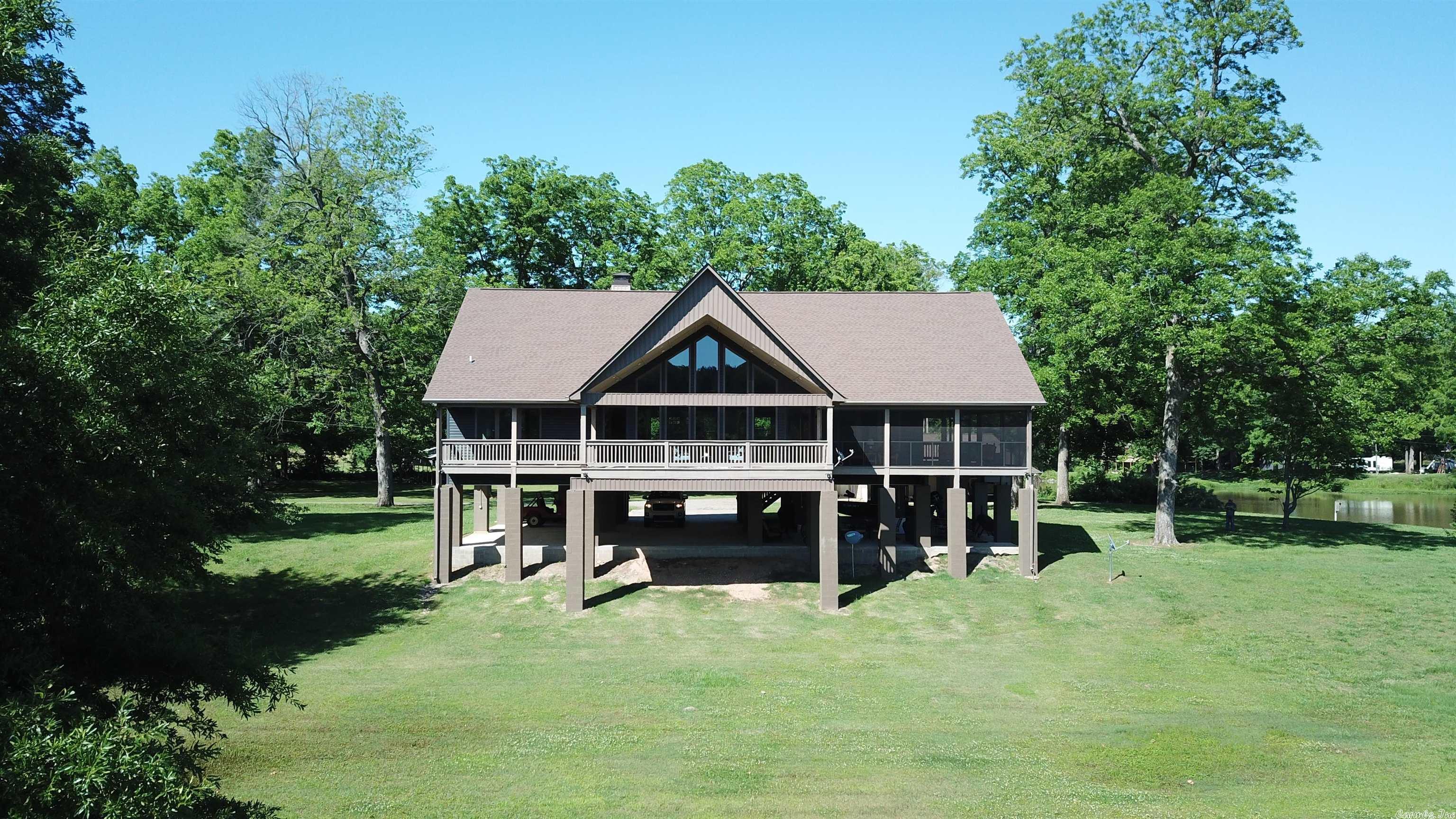 Beautiful home with several other amenities on the Arkansas River in tucker. property is built up on concrete pillars above fema floodplain. Property also includes a boat shed, shop, garden area, private boatramp with direct access into the arkansas river, and a 2 stall covered boat dock.