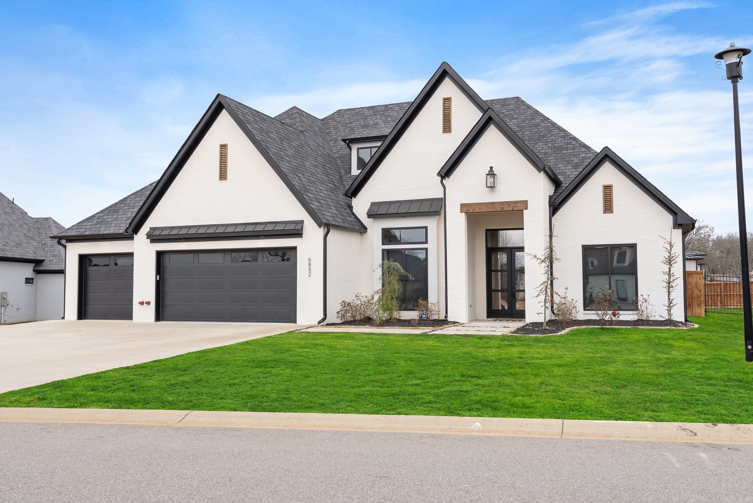 This exquisite home is nestled in the picturesque West Lake Subdivision, offering both serenity and sophistication. As you step inside, you're greeted by stunning hardwood floors that flow seamlessly throughout the living spaces. The gourmet kitchen is a chef’s dream, featuring a spacious island, a gas cooktop, dual wall ovens, and a generous walk-in pantry. The elegant living room showcases a sleek modern fireplace and custom-built floor-to-ceiling shelving, accented with integrated lighting that creates a warm, inviting atmosphere. Enjoy premium whole-home audio with customizable zoning options to suit your lifestyle. The first floor also includes three spacious bedrooms, two and a half luxurious bathrooms, and a dedicated office space. Upstairs, discover an additional bedroom and full bath, along with a state-of-the-art theater room, equipped with a 7.1.2 Dolby Digital DTS surround sound system for the ultimate cinematic experience. Step outside to an extraordinary outdoor living area, perfect for entertaining, featuring an impressive dining and cooking space, complemented by a stunning fire pit. Don’t miss the chance to see this exceptional home! (Agents, see remarks.)