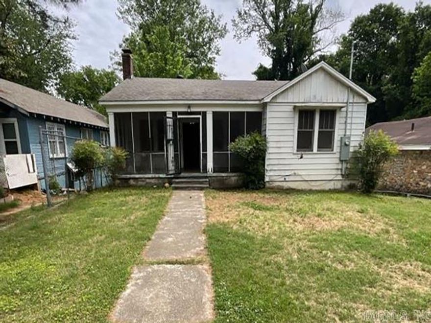 Located just minutes from Oaklawn Racing Casino Resort, this 2-bedroom, 1-bath home offers strong potential for a rental, flip, or personal renovation project. The home features a spacious living area with original hardwood floors, a functional layout, and built-ins. The screened-in front porch adds extra usable space, while the back deck overlooks a shaded yard. Kitchen and interior finishes are ready for improvement with the structure and layout providing a solid starting point. Conveniently located near dining, entertainment, and all that Hot Springs has to offer, this property is a great opportunity to create something special in a growing area. Just 15 minutes from Lake Hamilton! No seller property disclosure. Buyers are encouraged to use their own methods and measurements for the lot and square footage.