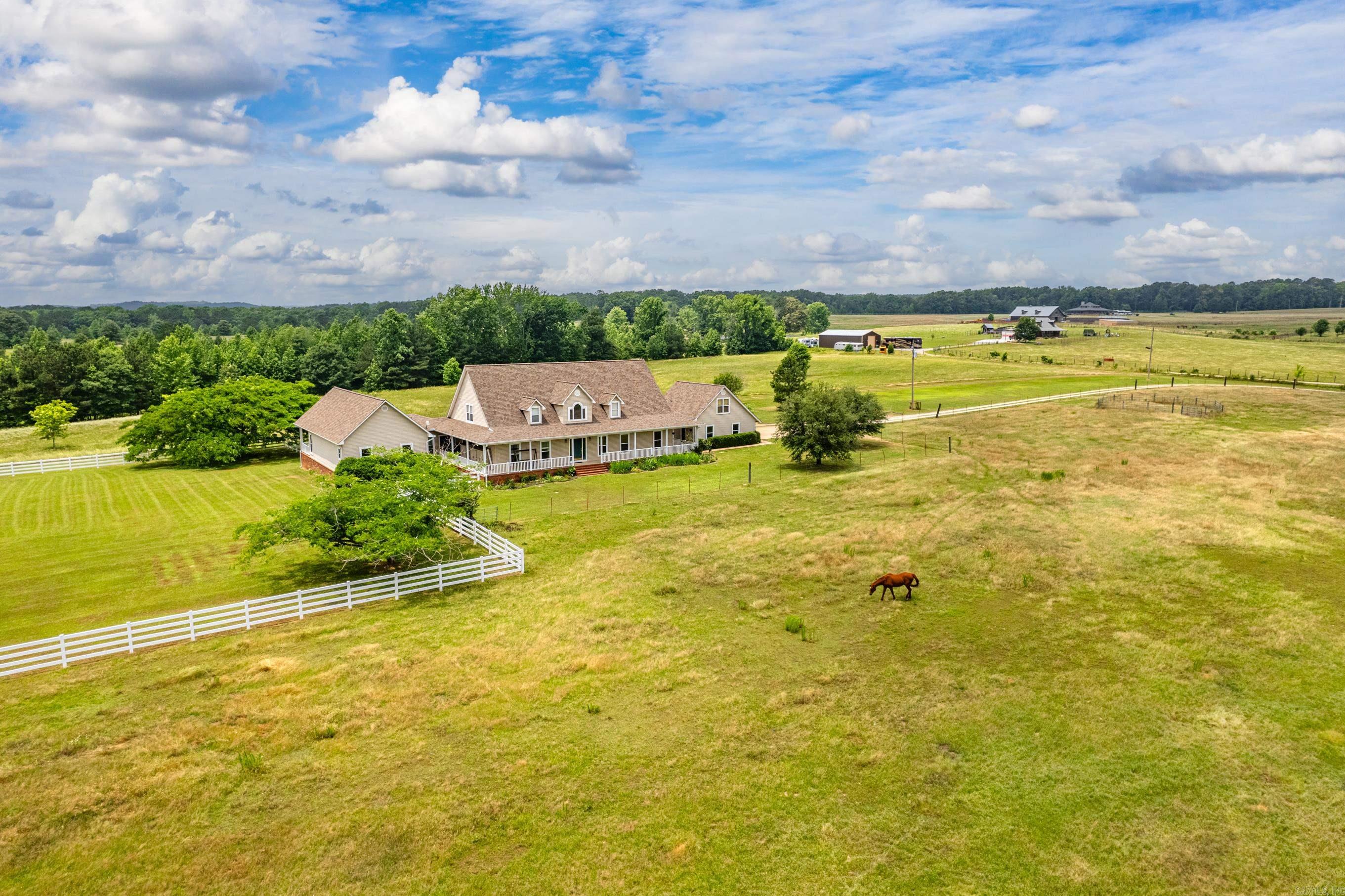 Welcome home!!! If privacy & seclusion are what youāre looking for, THIS IS IT! Have your own private paradise on this breathtaking 20 acre property! This magnificent estate features a luxurious 4500 sqft home, perfect for those seeking tranquility and space. Youāll enjoy endless hours relaxing on the wrap around porch plus the newly built deck is great for outdoor entertaining or just enjoying the scenery. The spacious living area includes- 4 bdrms, 3.5 baths, large kitchen, formal dining, spacious sunroom, walk-in storm shelter, oversized laundry & mudroom, office/study & so much more. 2 oversized suites are on the main level, the primary offers direct access to the back porch. Upstairs youāll find 2 large bedrooms with large closets, lots of storage space in each and full bath. Expansive windows all throughout bring in so much natural sunlight. Home and barn have a new roof, new gutters & siding installed. Home is on a ground source heat pump system which ensures your utility costs are kept to a minimum. All appliances convey. 2 large barns. 500sqft loft apt. Adjacent 20 acres- see MLS listing #24031165