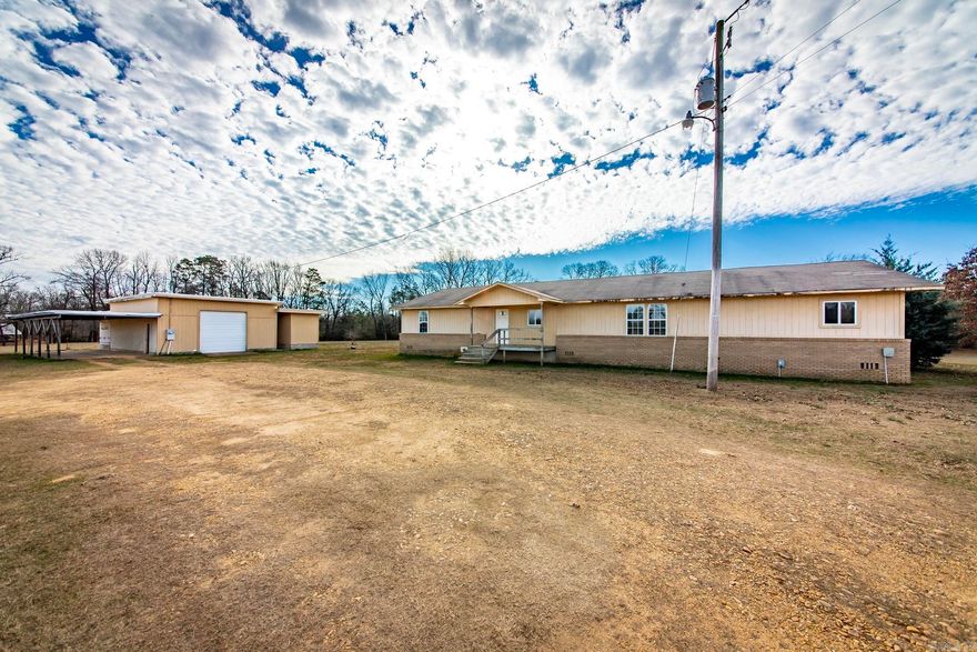 The property features highway access with a gravel driveway, city water, electric on site, and a private septic system, providing a strong foundation for a variety of uses. Large, fenced garden space ideal for growing and protecting plants from wildlife. A substantial shop structure with significant investment adds versatility and may offer potential for additional living quarters, guest space, or workspace, subject to buyer verification and any required approvals. The land lays well with a mix of open and private areas, making it suitable for a homesite, hobby farm, or recreational use. Situated in a quiet rural setting while remaining conveniently accessible, this property presents an excellent opportunity to purchase acreage with utilities and improvements already established.