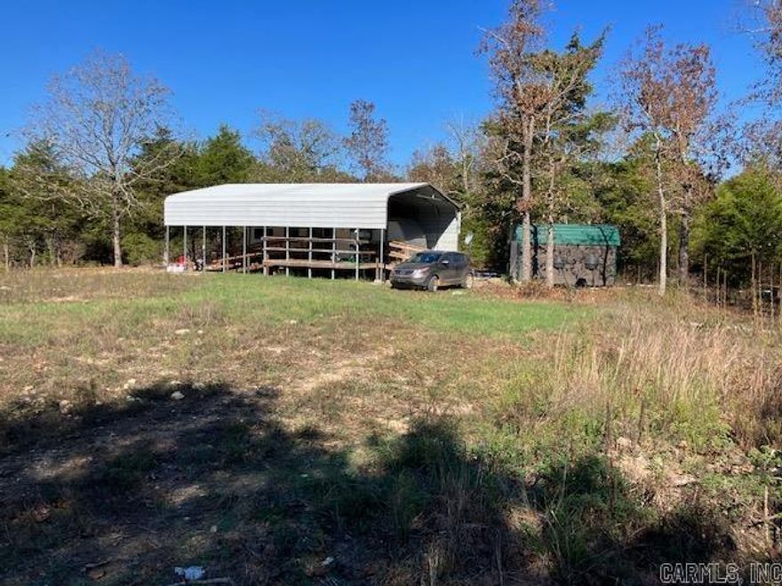 Hunters or Homesteaders Paradise! This private 20 acre M/L parcel has everything you need to start hunting or homesteading immediately including well, electric, and septic utilities. There is a 30x40 canopy structure for parking a RV under, along with an outbuilding that has power run to it.   This property shares a 638 foot border with and adjoins the 3,768 acre Fouche Creek conservation area in Missouri that offers endless hunting, fishing, camping and trail riding opportunities. There is an extensive trail system through the 20 acres itself as well a food plot and hunting blind.   The travel trailer in the pictures can be purchased with the property for an additional price.
