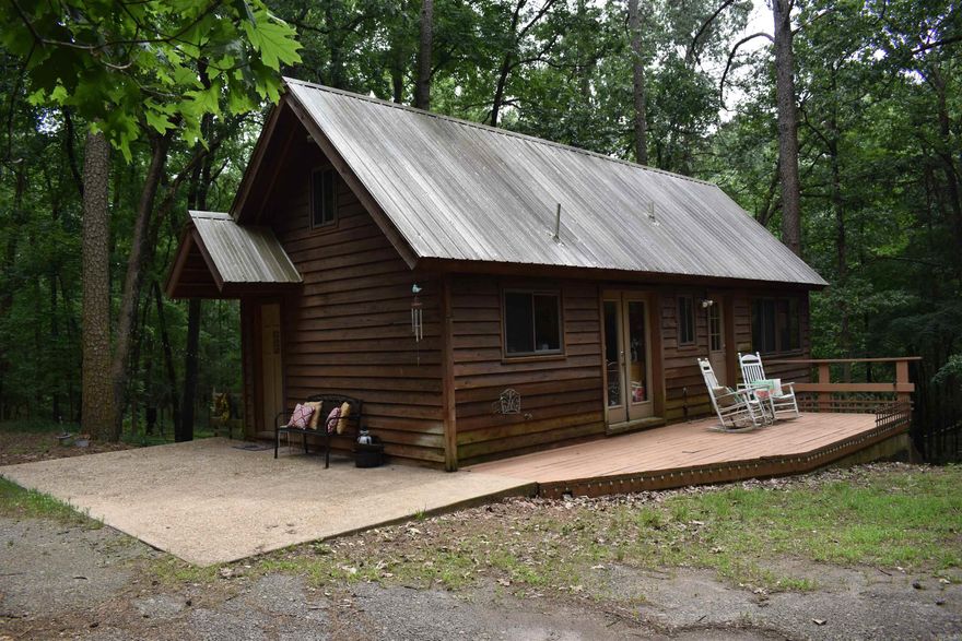 If you are looking for your own secluded property away from neighbors but still within 10 minutes of Downtown Ozark, then look no further! This quaint cabin is the perfect place to call your own. The home is designed with 2 full bedrooms and 1.5 baths, as well as, a loft for sleeping with extra beds that is not included in the square footage. The stunning views outside the living room windows give you a panoramic view of the property with your own creek and various wildlife. The home also boasts beautiful hardwood floors and vaulted ceilings. On the outside you will find several places to entertain. From the deck on the upper floor, to the patio/hot tub area on the bottom. There is also 2 storage sheds made to match the home and a covered carport that conveys as well. If you are wanting a property that would be the perfect air bnb or just want you own little piece of the outdoors then be sure to schedule your showing today!